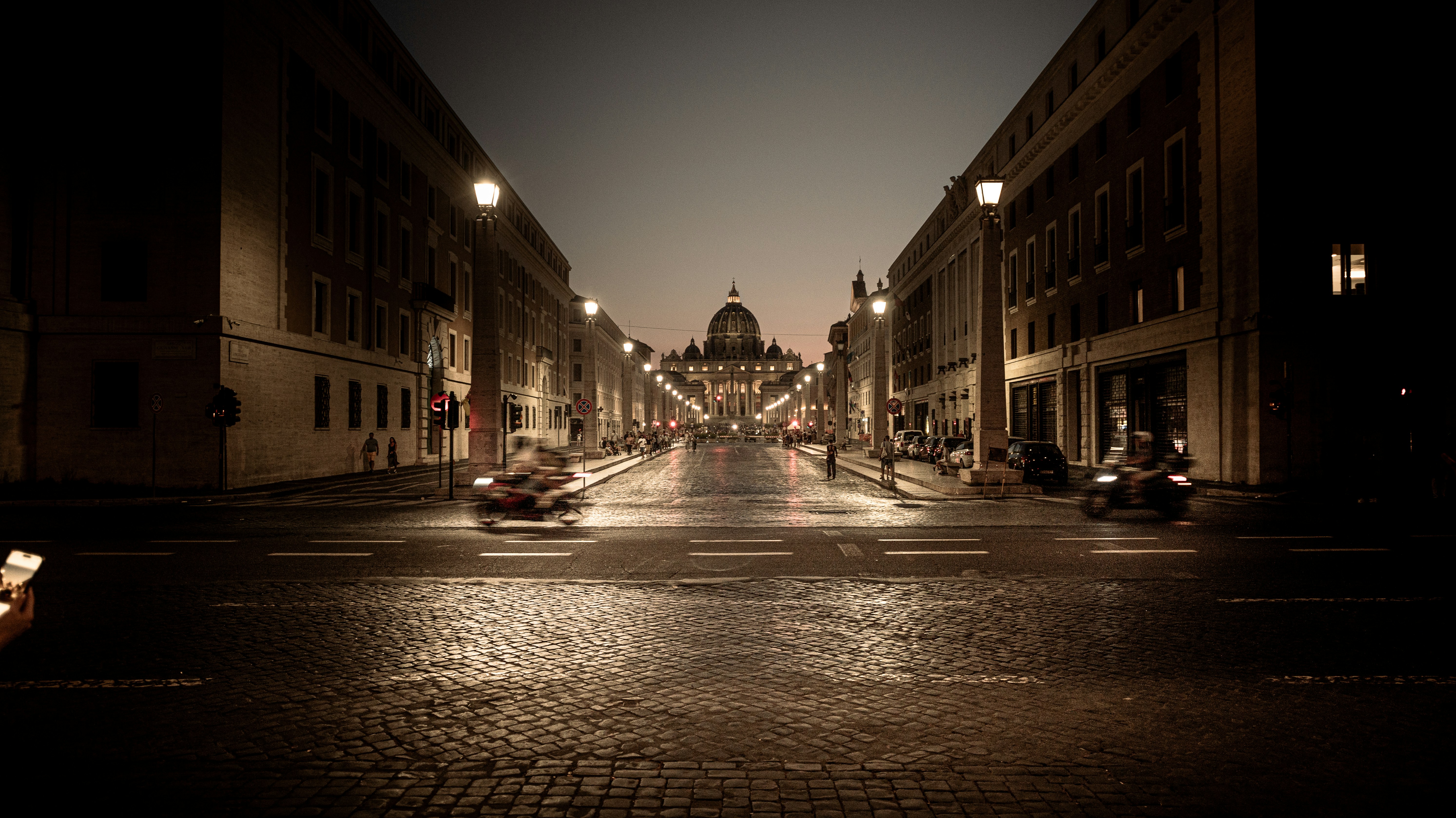 Street leading to a domed building at night