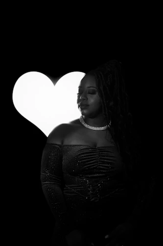Woman with eyes closed in front of a glowing heart