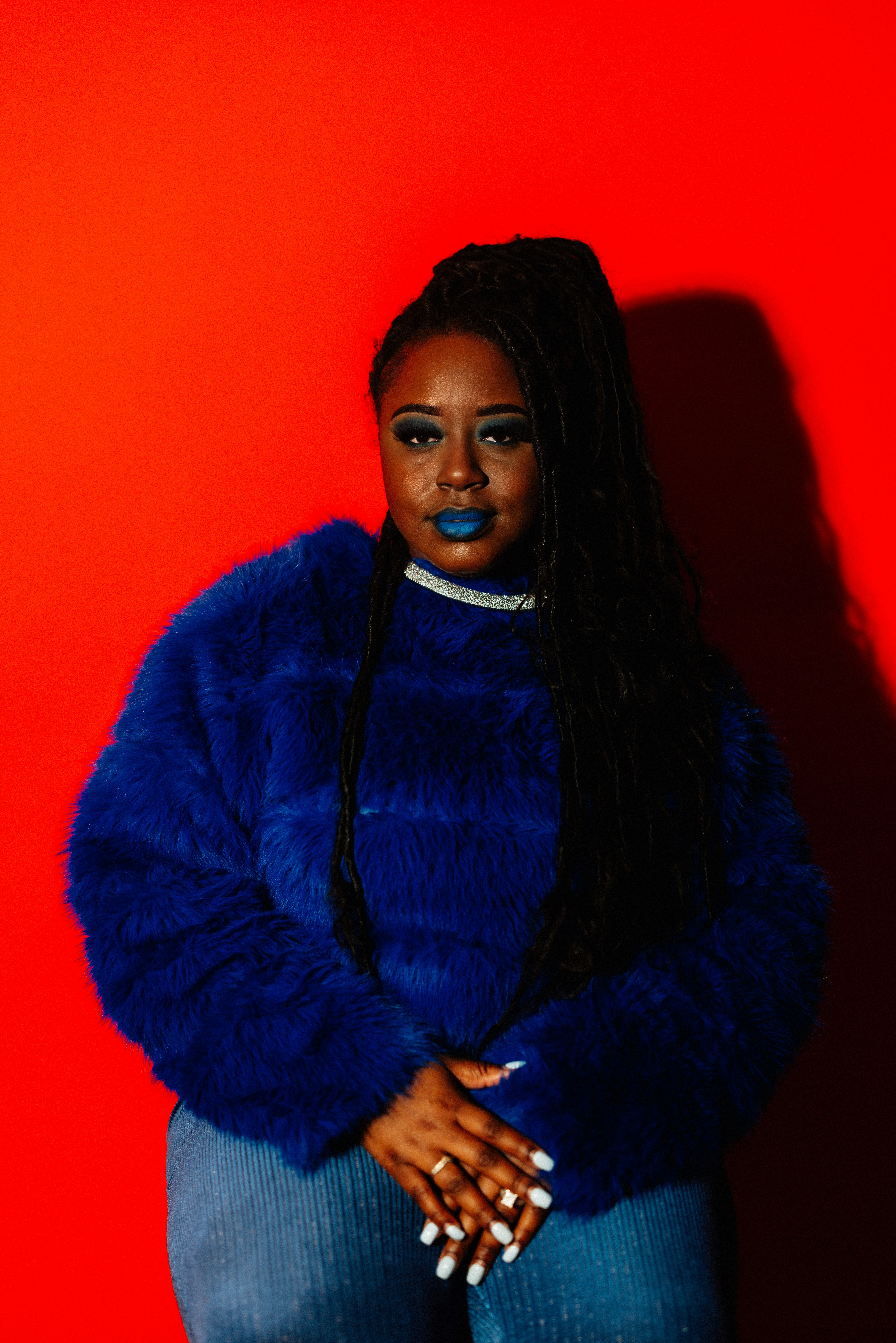 Woman with blue lipstick and fuzzy sweater