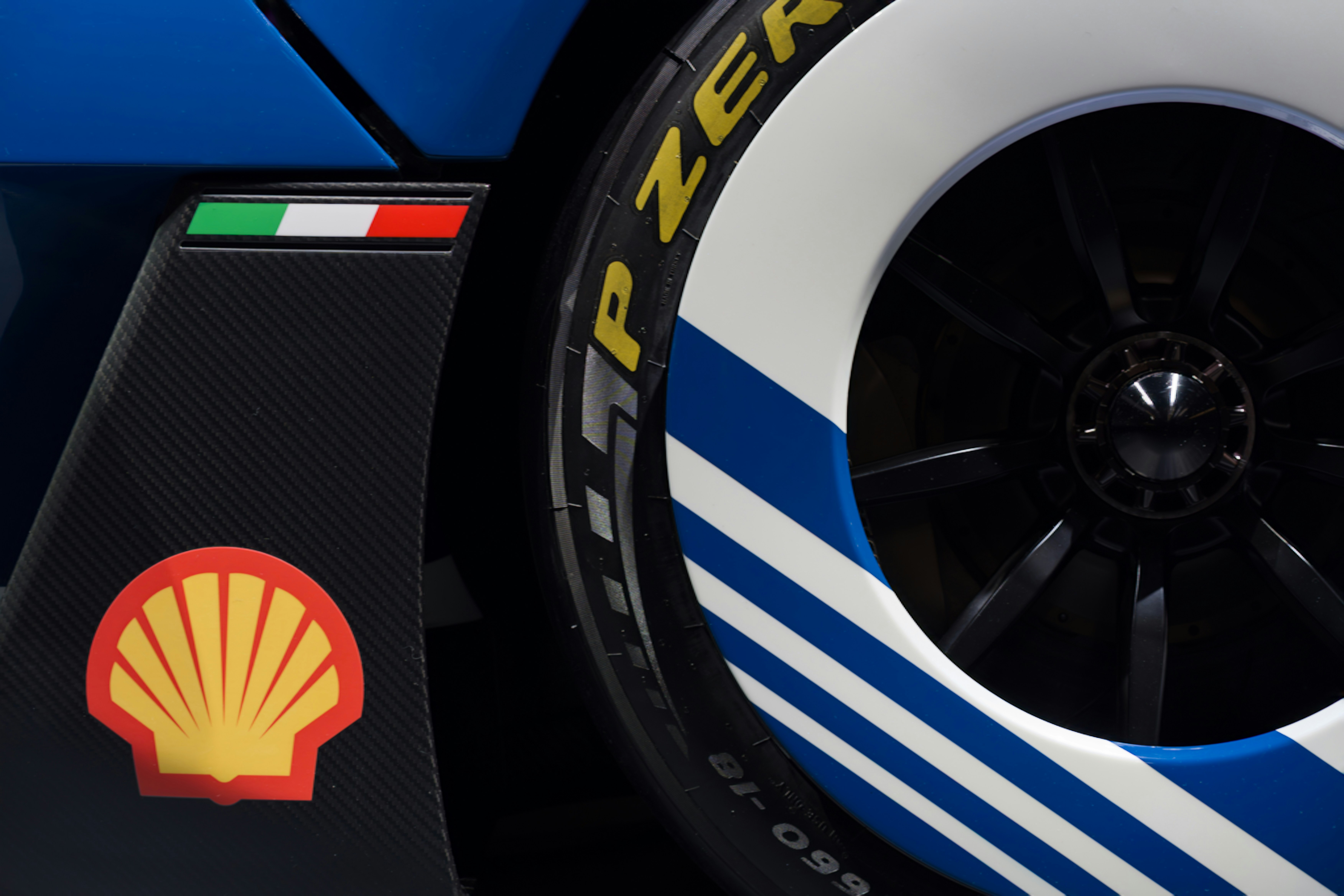 Close-up of a race car wheel with shell logo