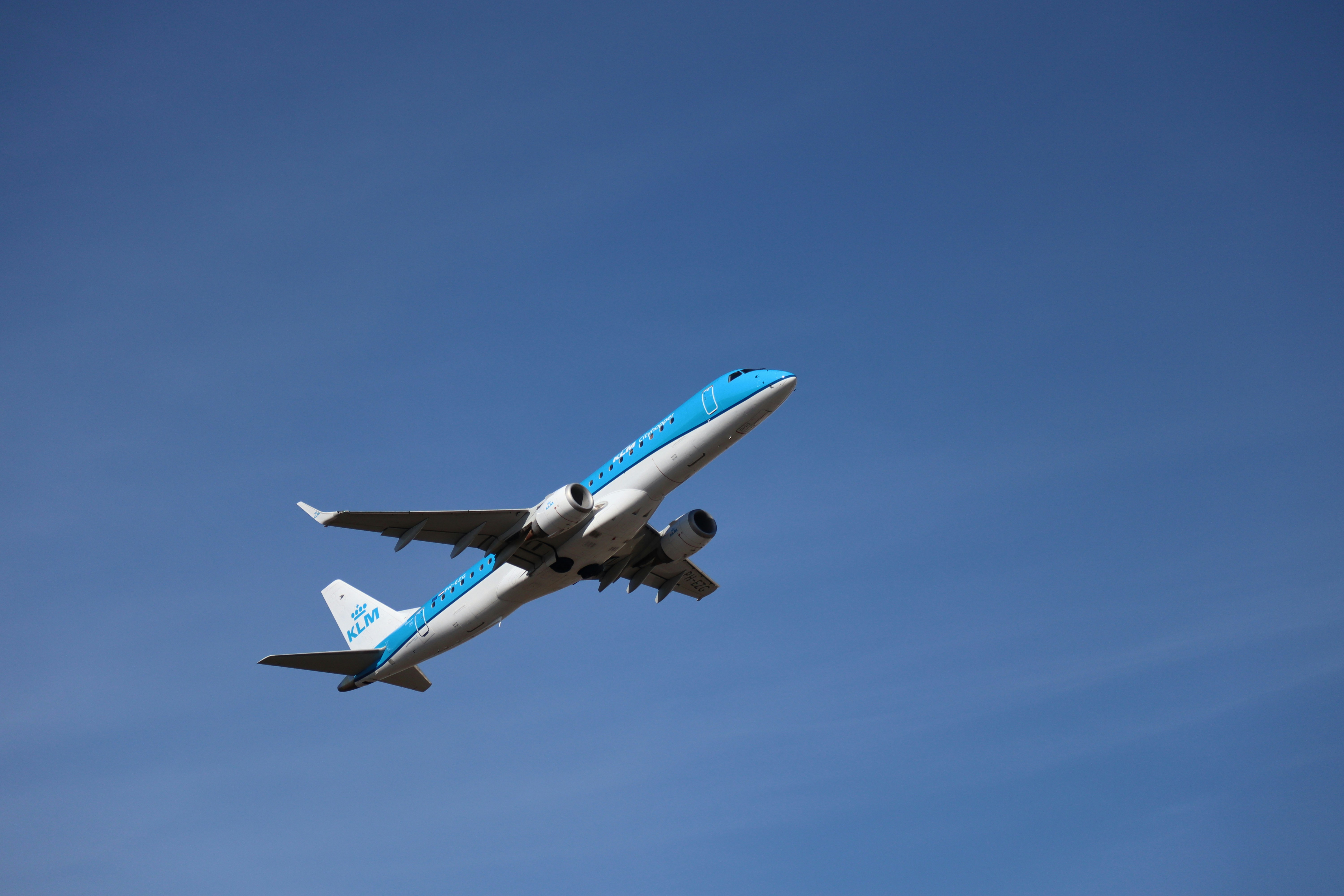 Un avión de KLM ascendiendo hacia un cielo azul despejado
