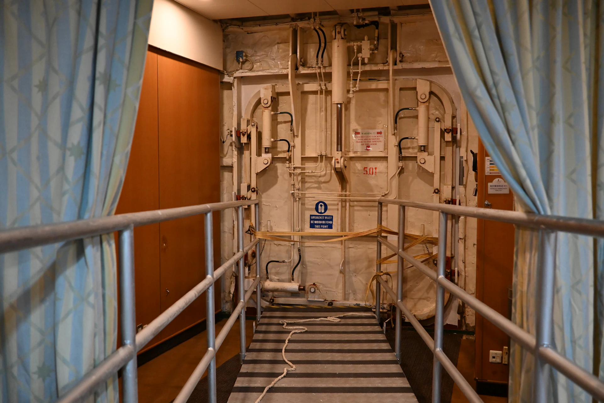 Metal walkway leads to a large industrial door