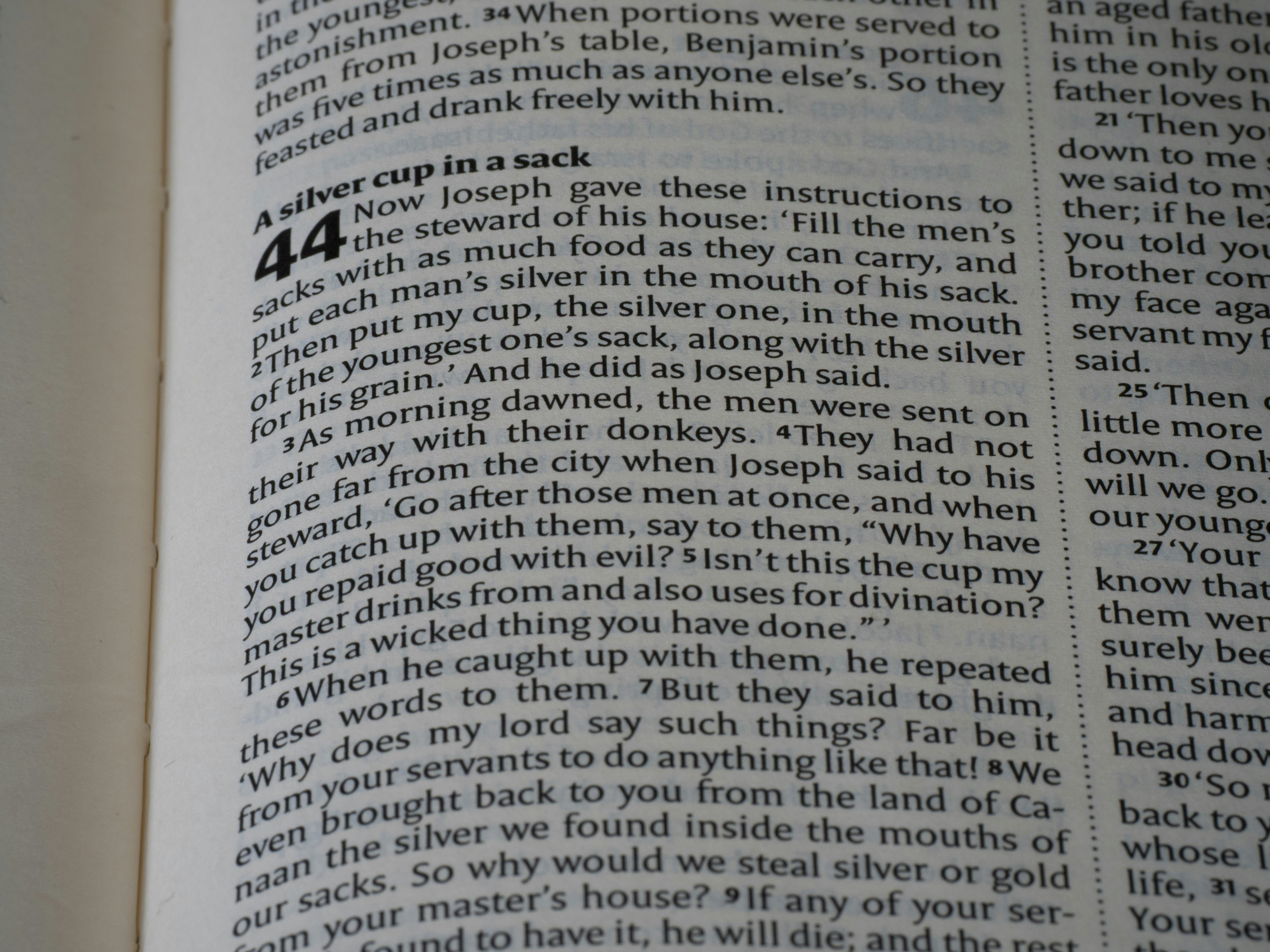 Close-up of an open bible with text visible.