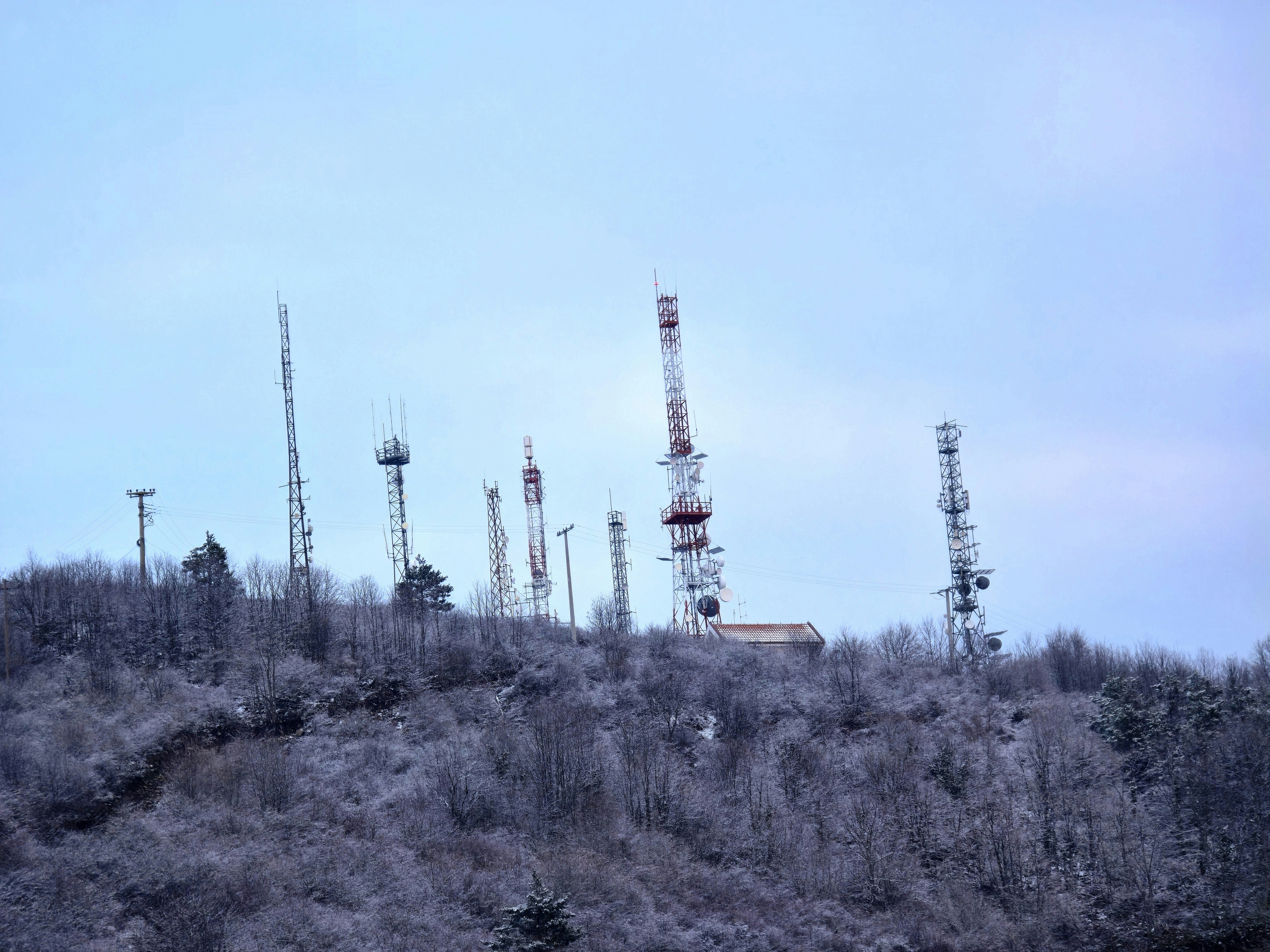Communication towers on a snow-covered hill.