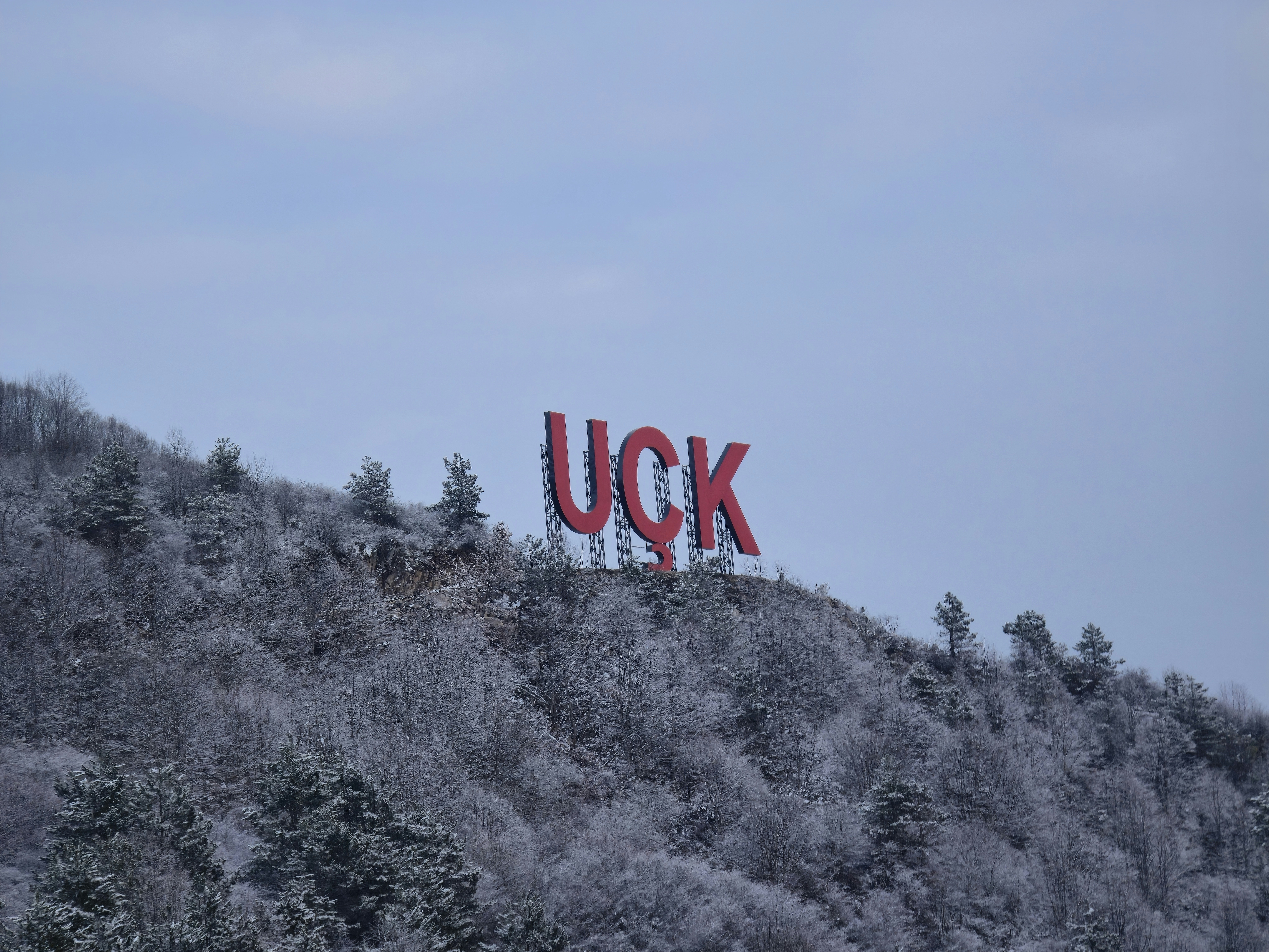 Large red letters spell uck on snowy hill