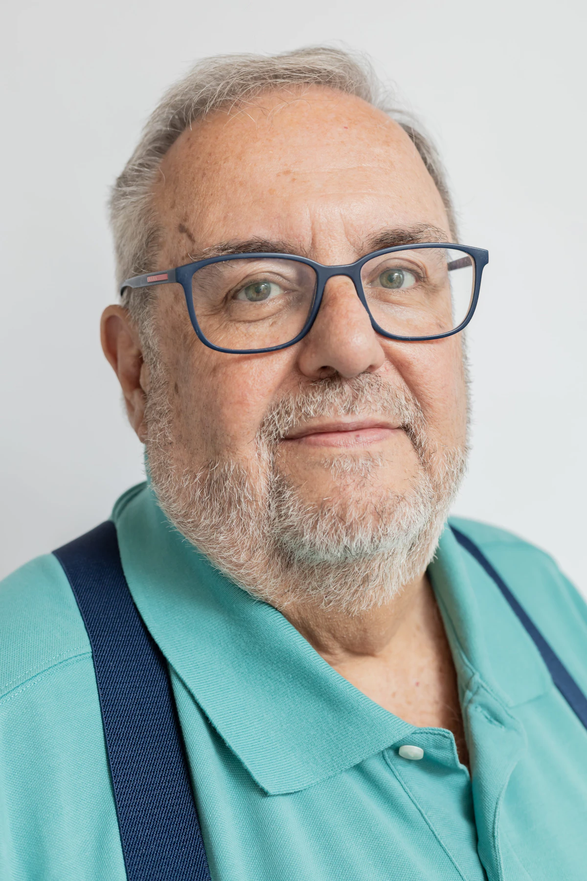 An older man in glasses smiling