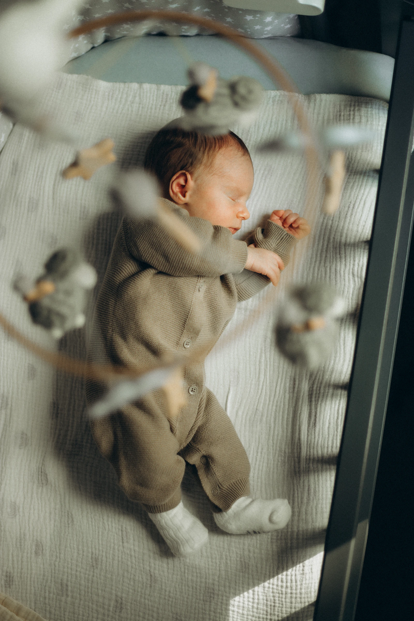 A newborn sleeping peacefully in a crib