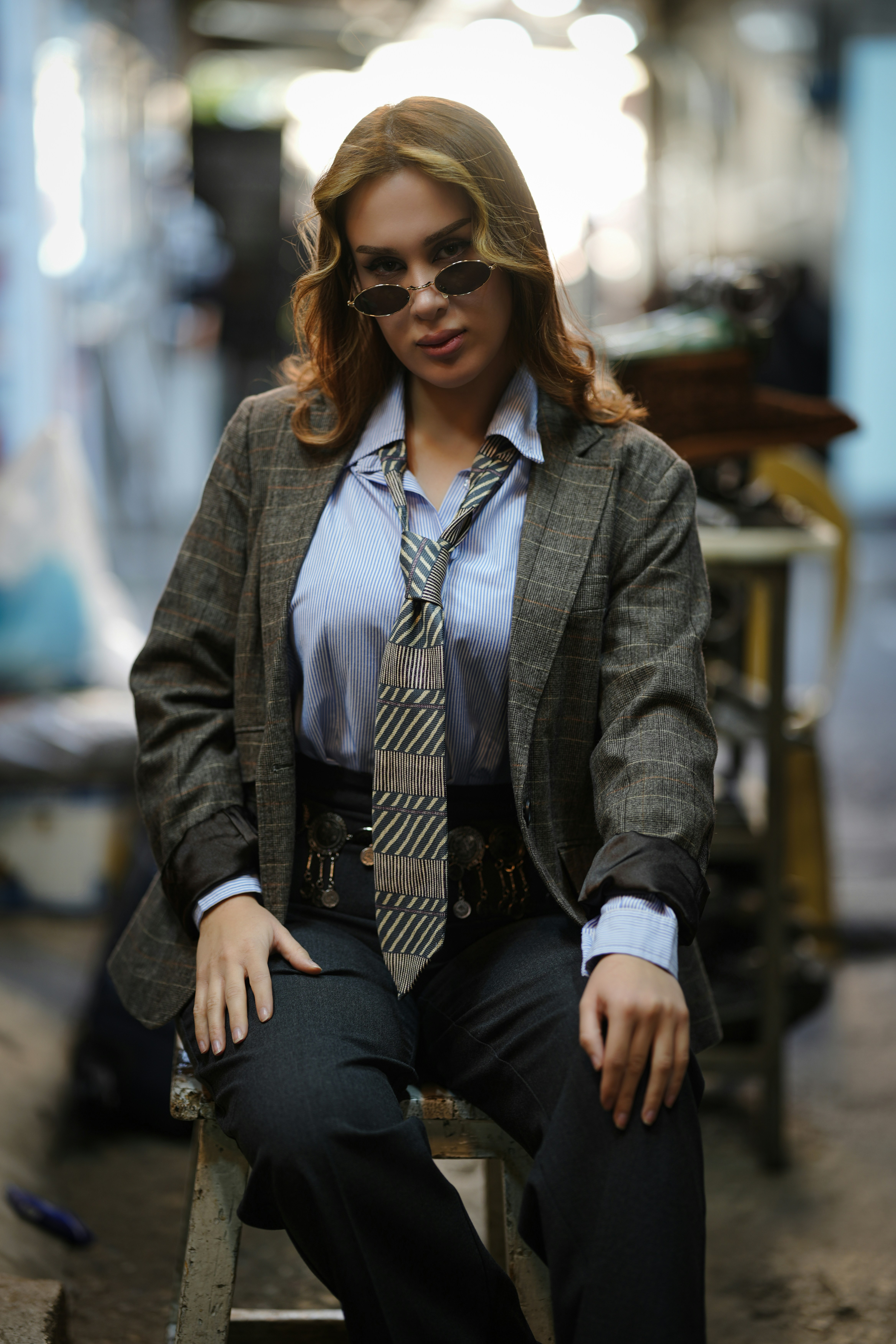 Woman in a suit and tie posing confidently