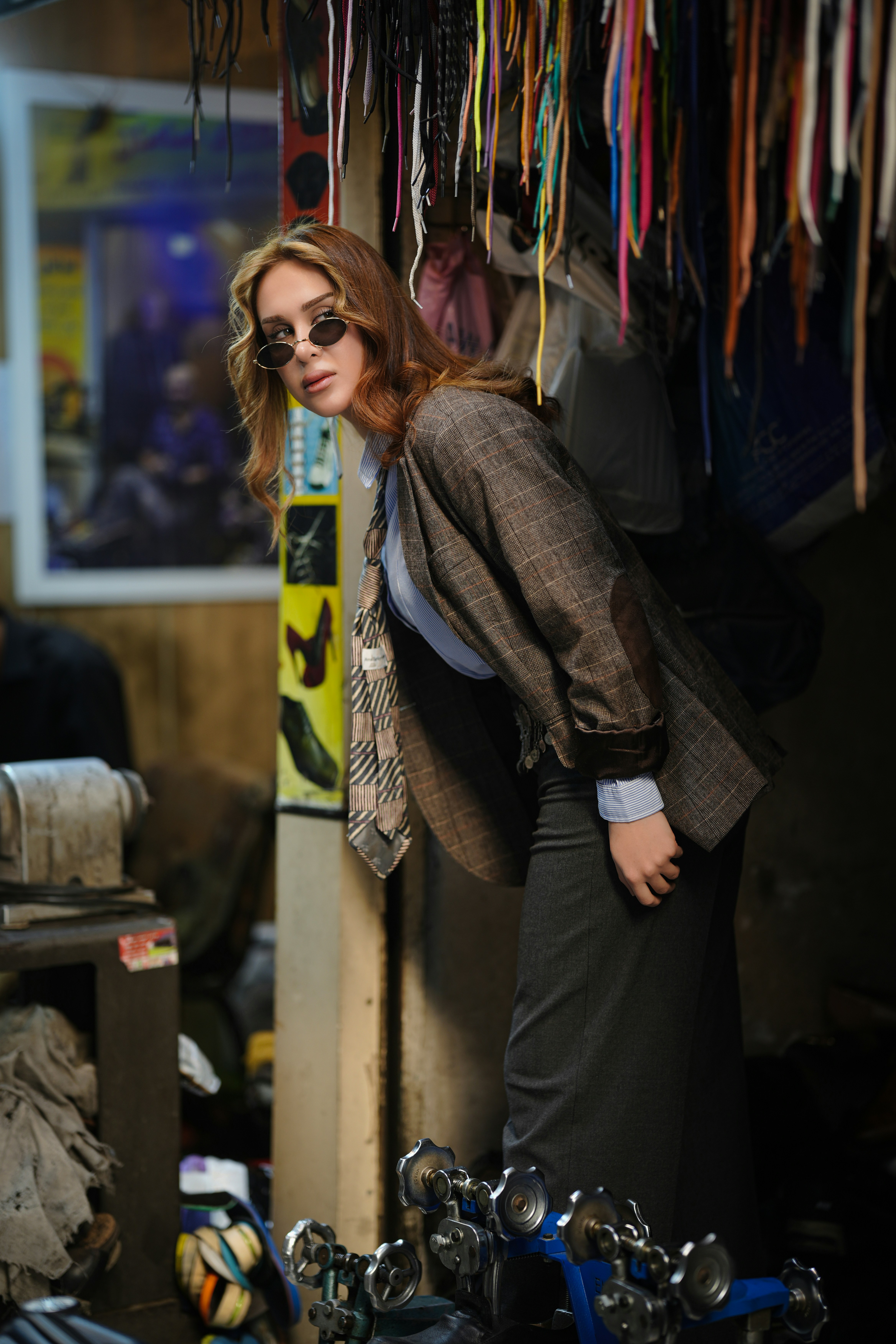 Woman in stylish outfit posing in workshop