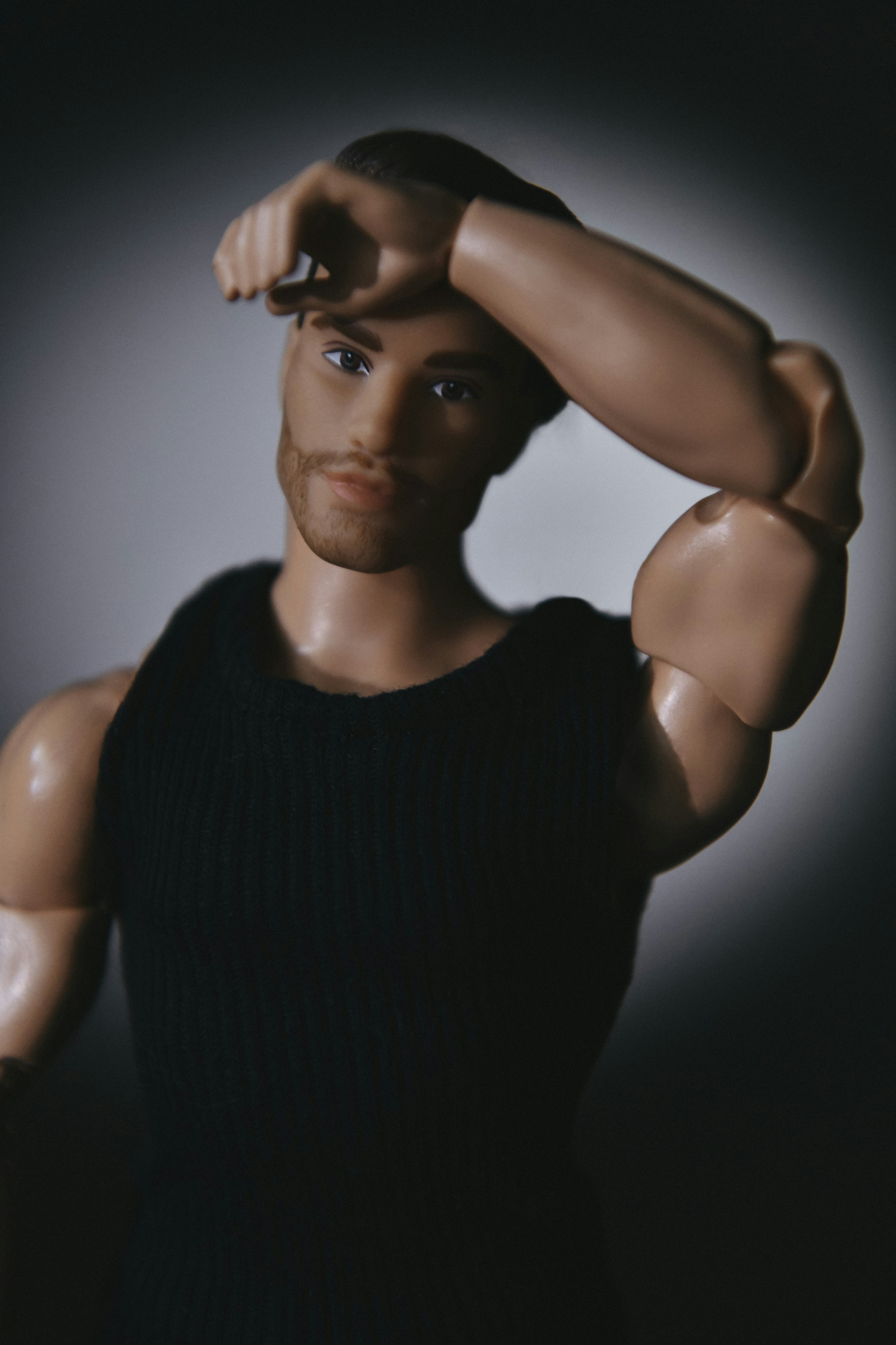 Man in black tank top with arm raised