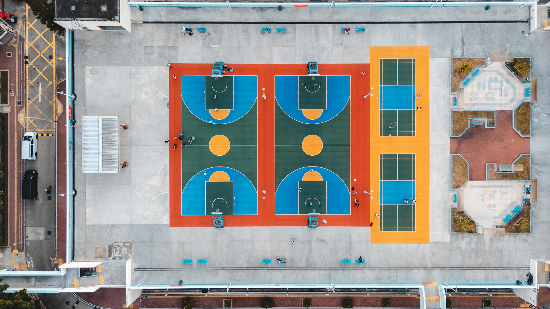 Colorful outdoor basketball and tennis courts from above
