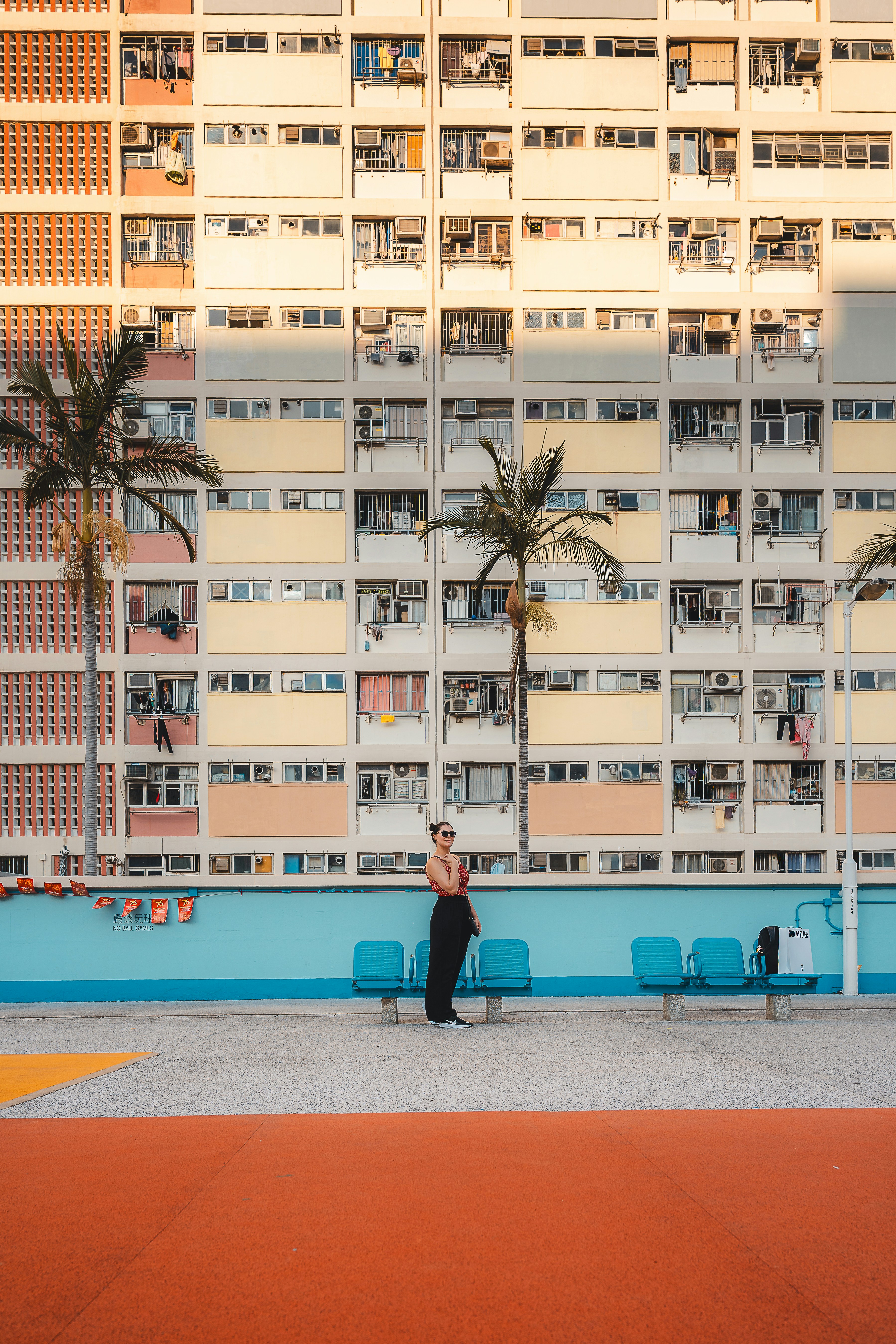 Woman standing in front of colorful apartment buildings