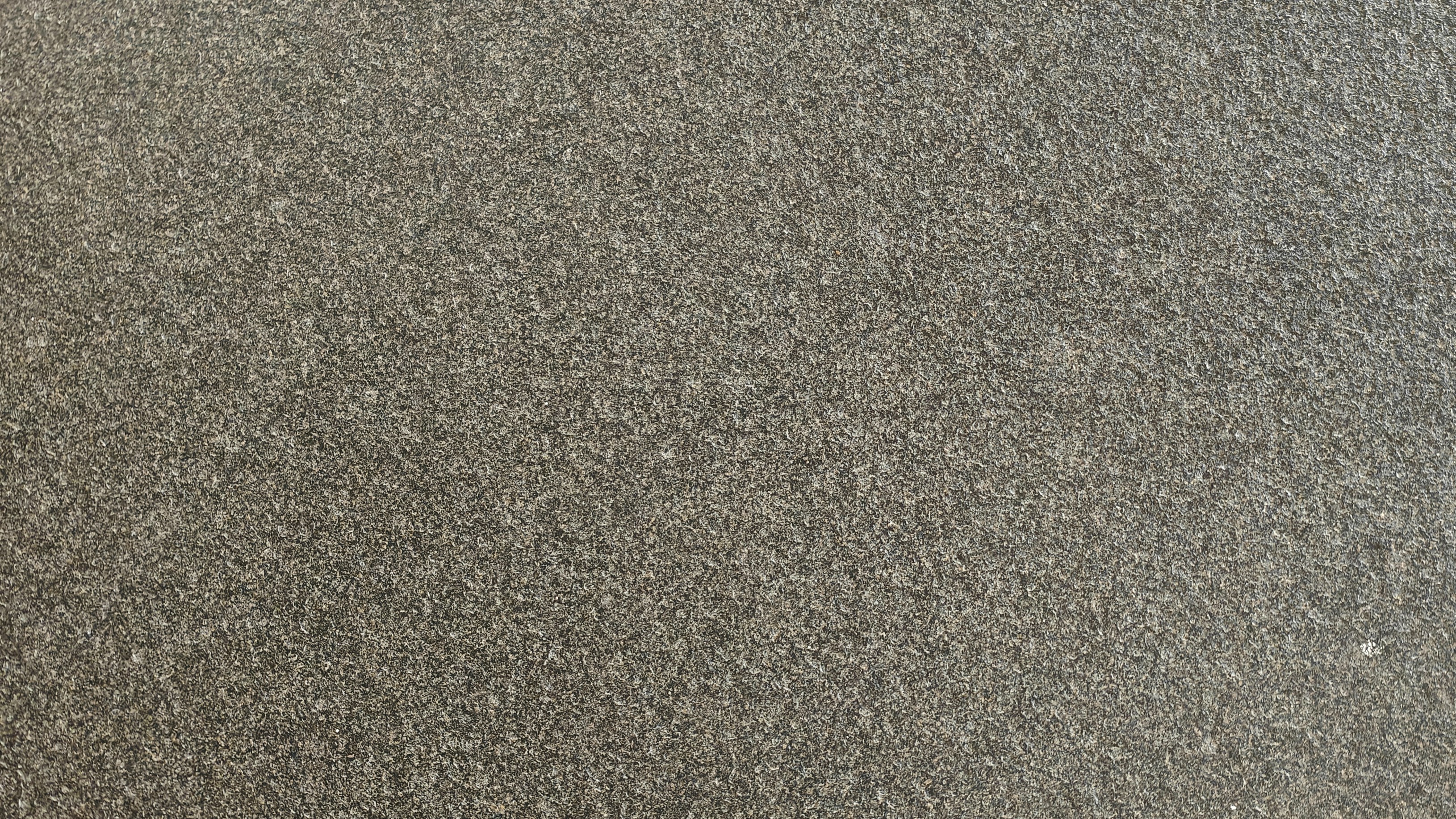 A textured grey surface with subtle speckles