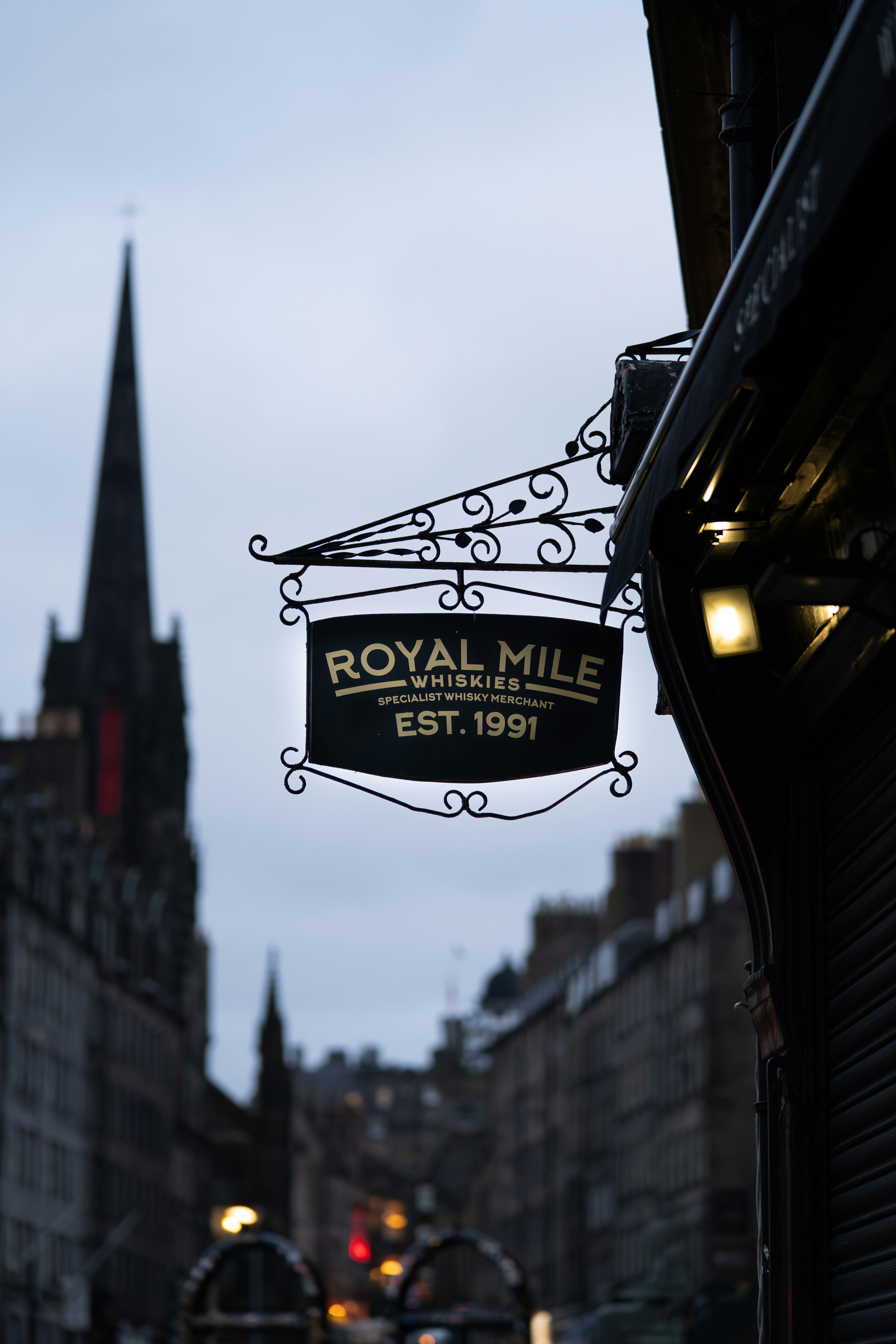 Royal mile whiskies sign hanging outside building