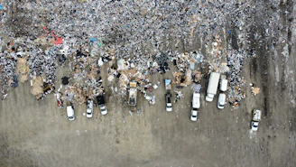 Aerial view of a large landfill with garbage trucks