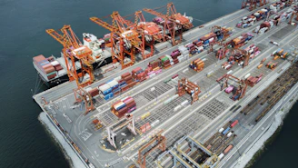 Busy shipping port with cranes and cargo containers.