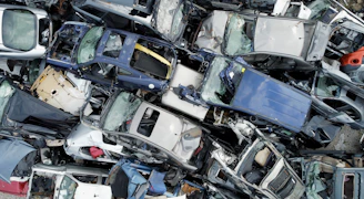 Pile of crushed and wrecked cars at junkyard