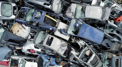 Pile of crushed and wrecked cars at junkyard