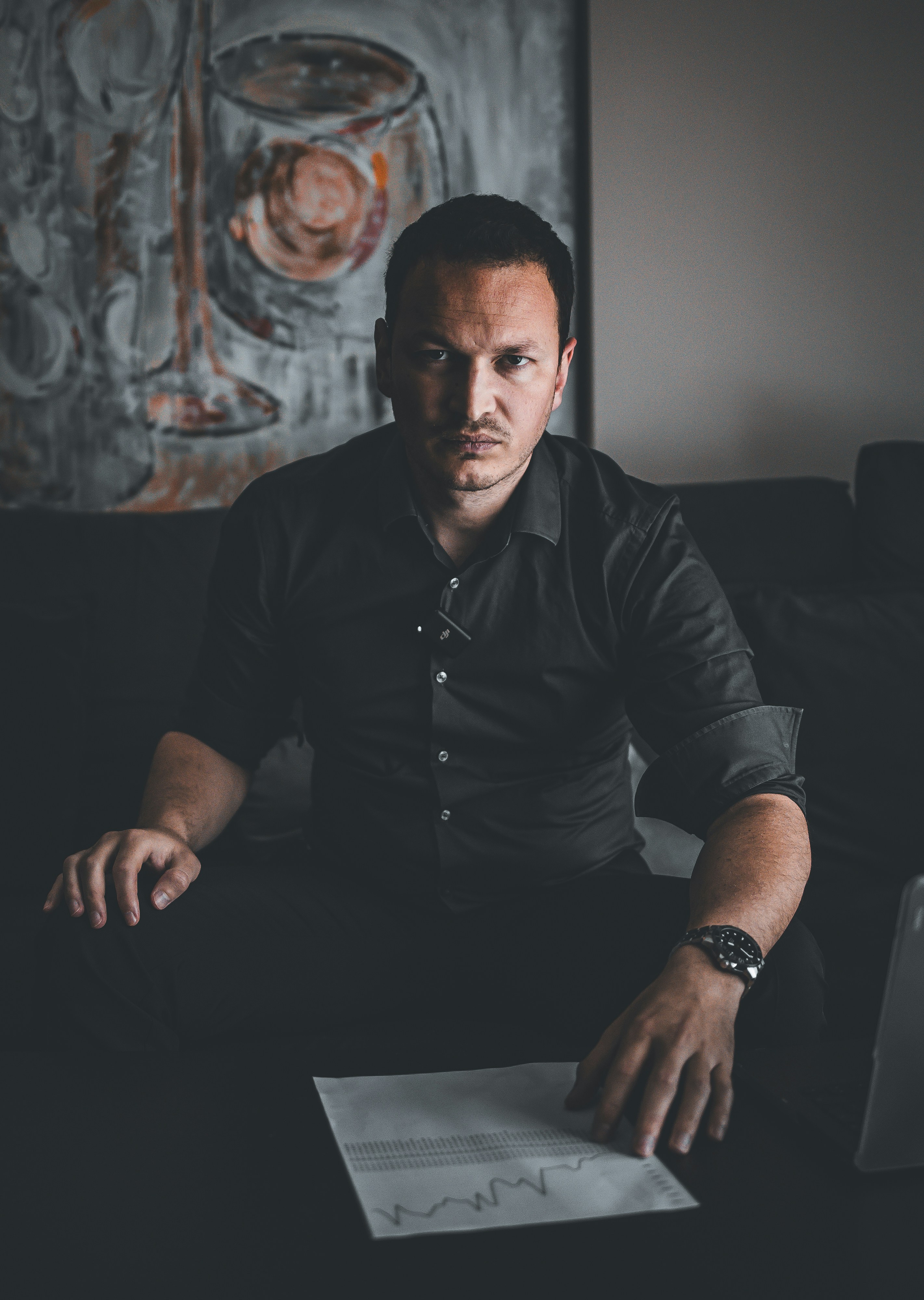 A man sits at a table with papers.