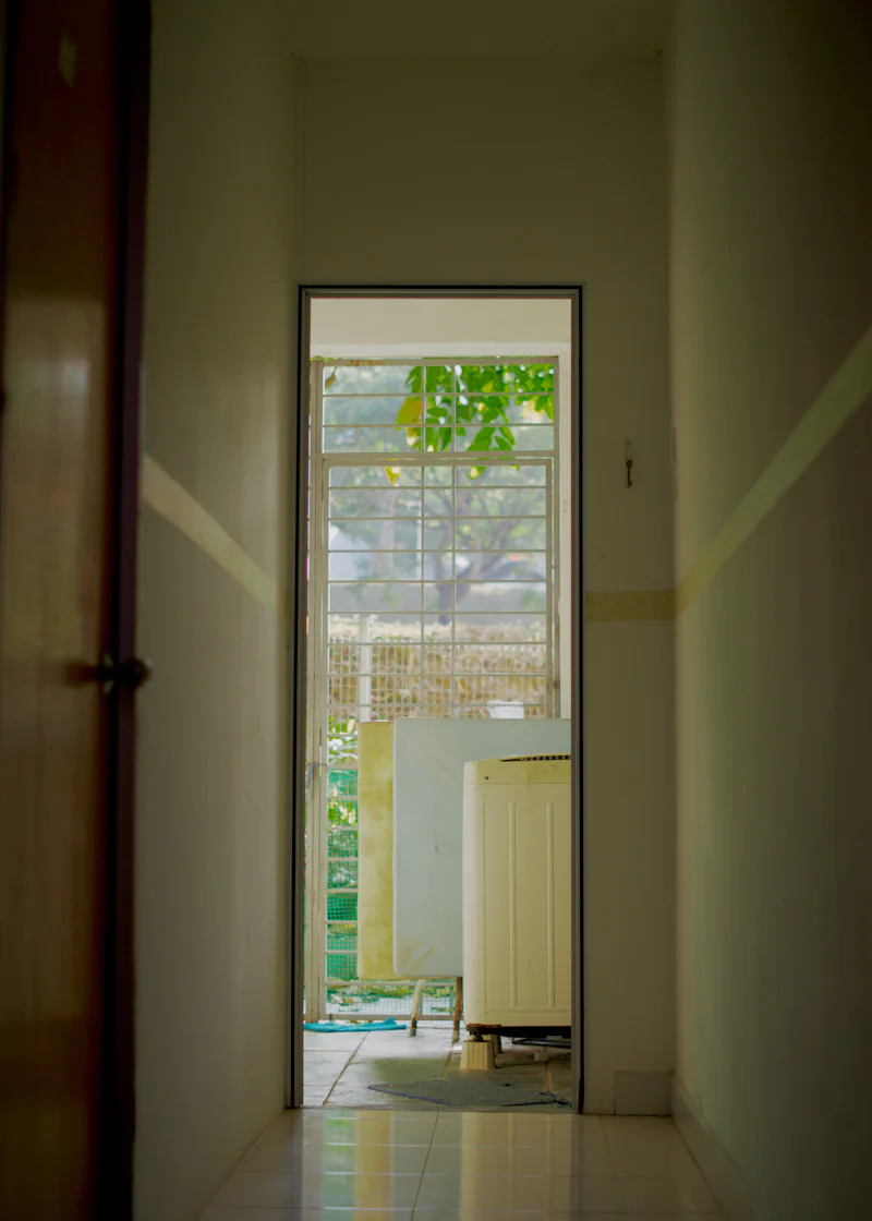 View through a doorway to a laundry area and outside
