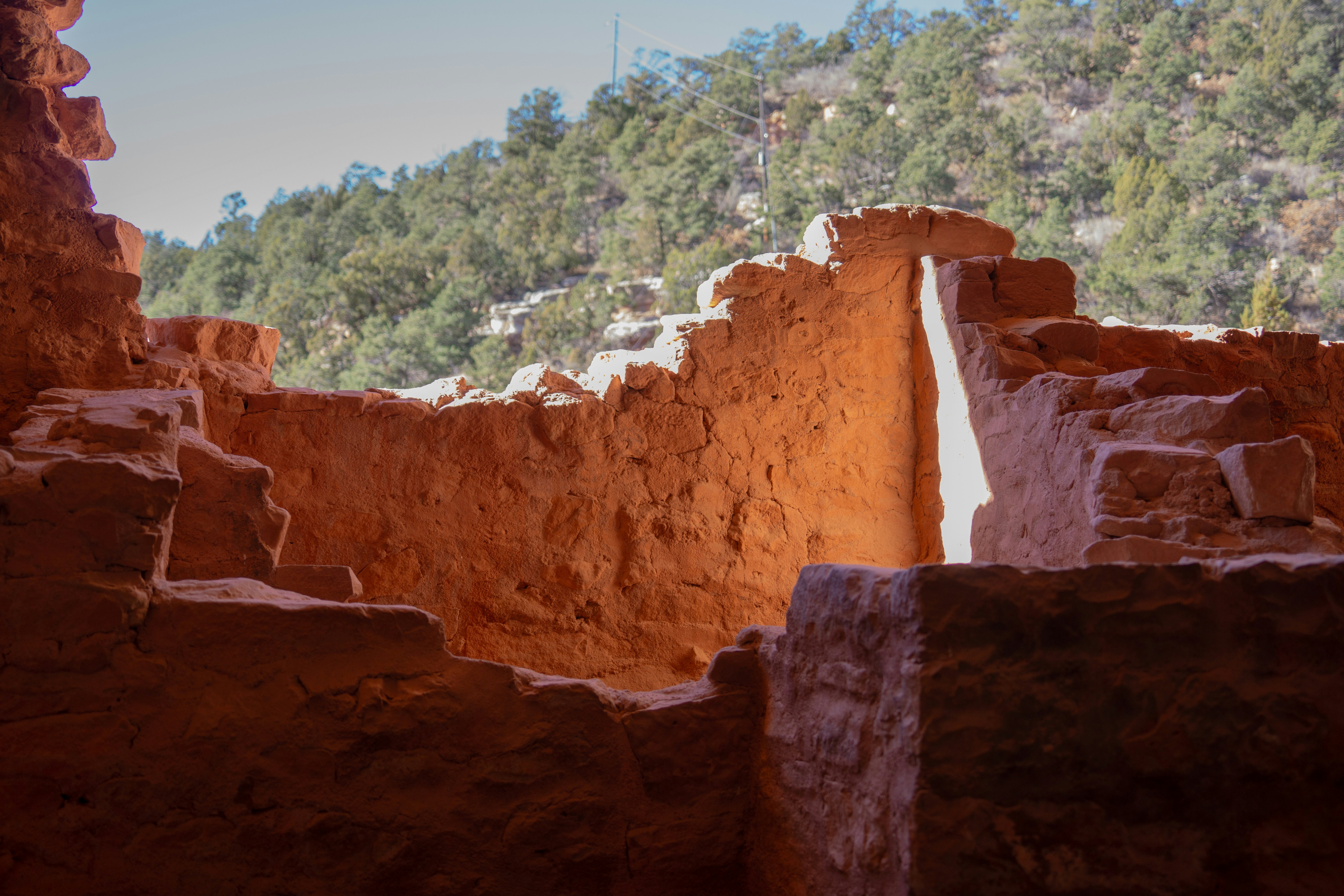 Ancient cliff dwelling ruins with sunlit interior