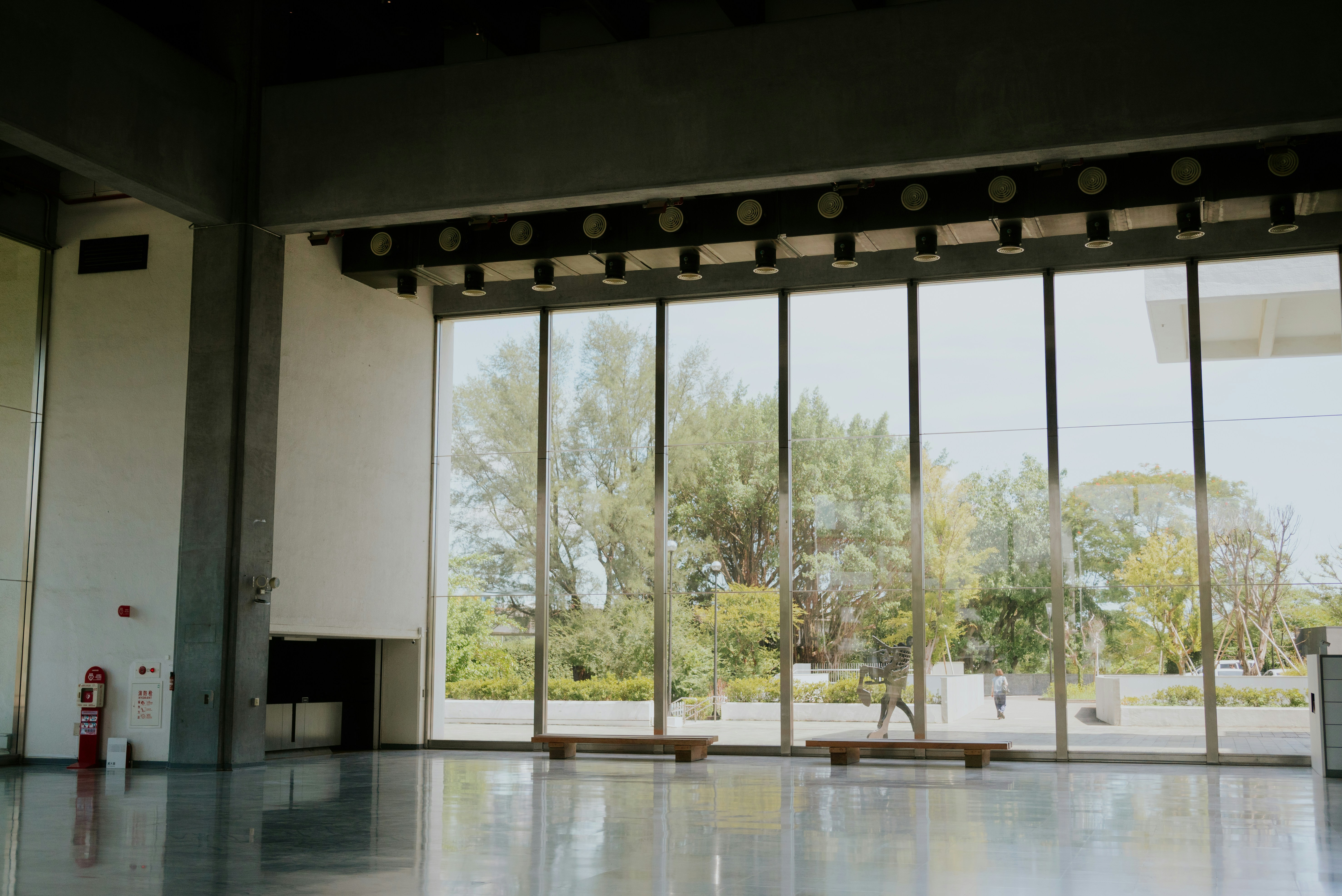 Empty room with large windows overlooking trees