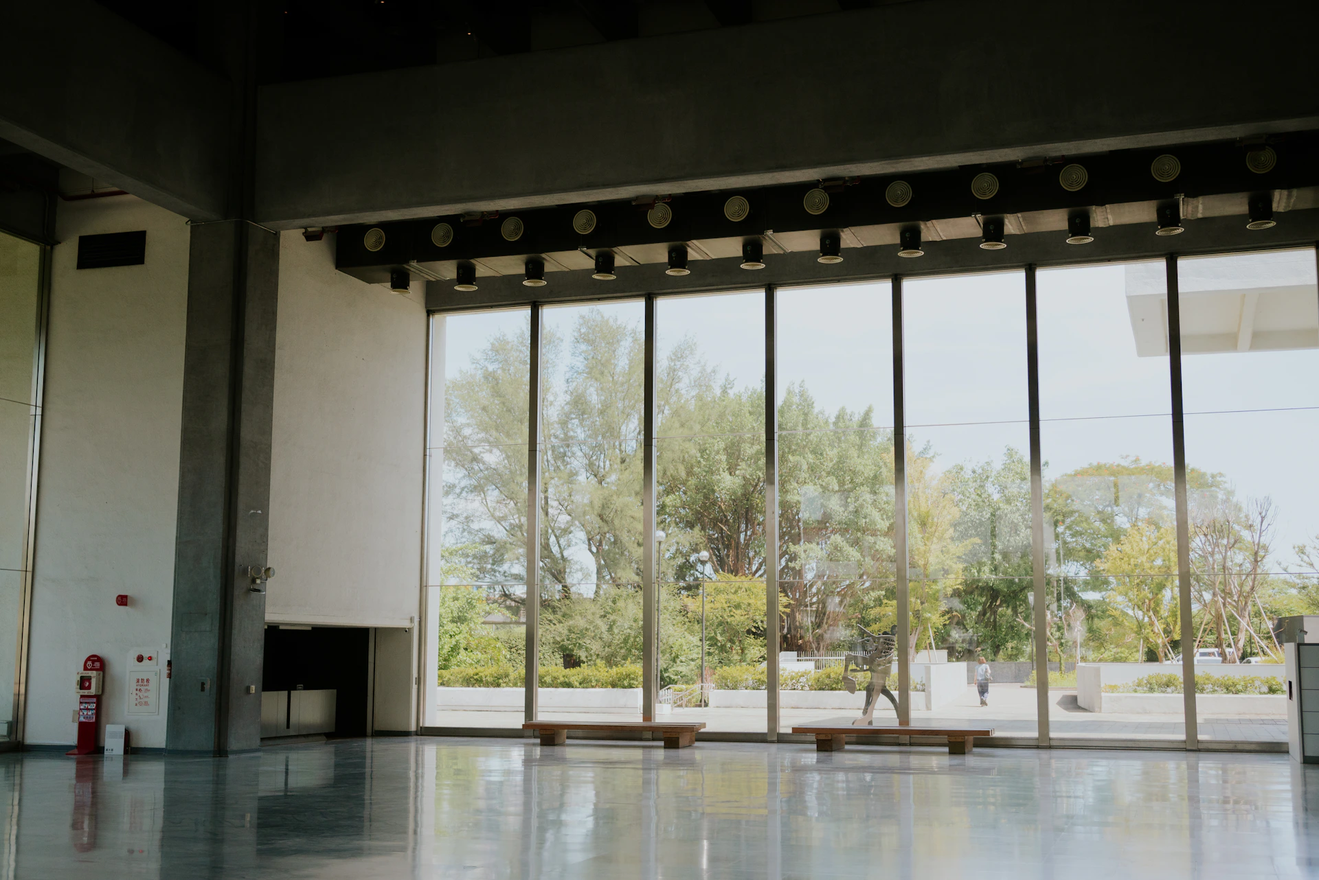 Empty room with large windows overlooking trees