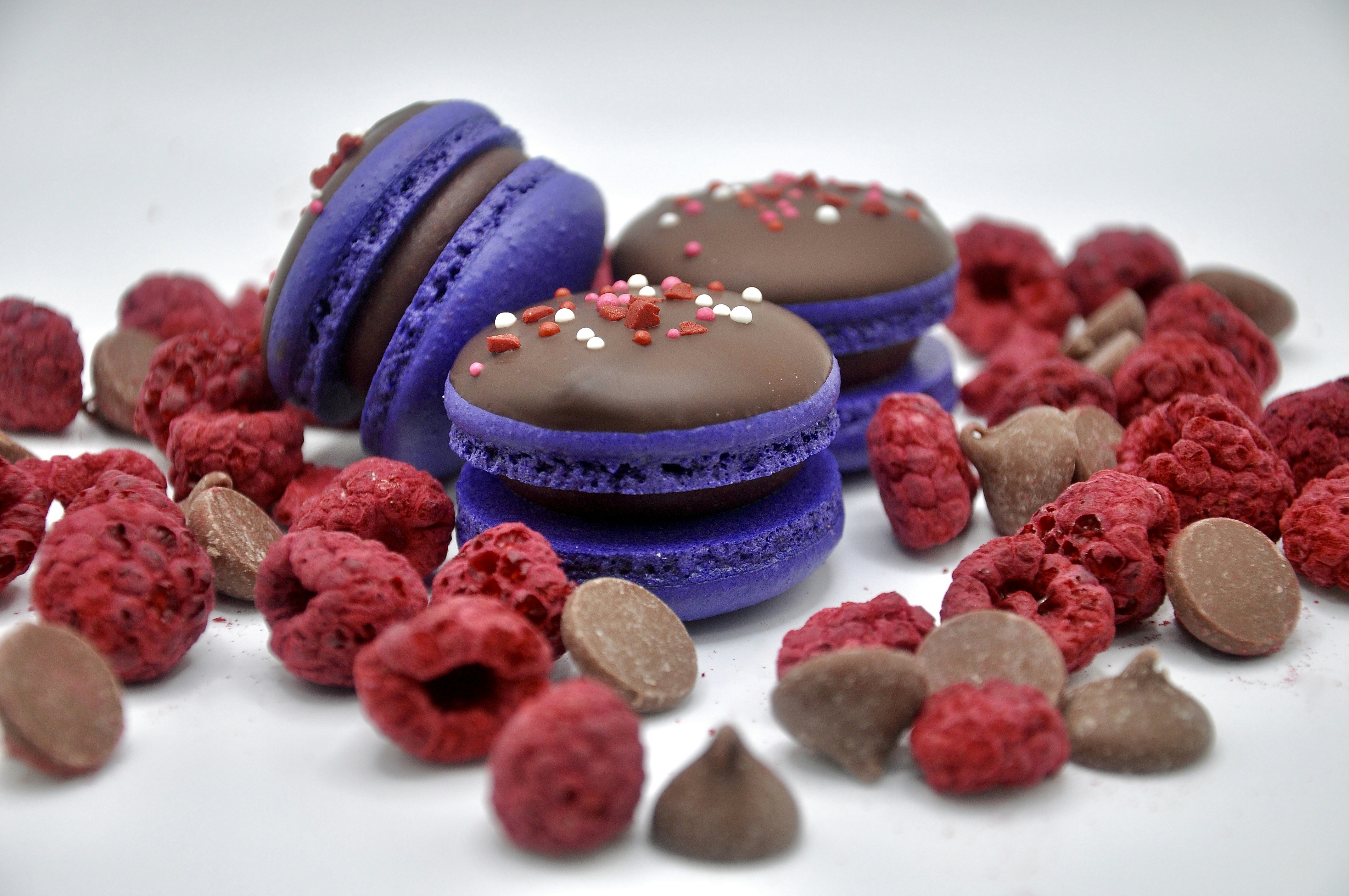 Purple macarons with chocolate, raspberries, and chocolate chips