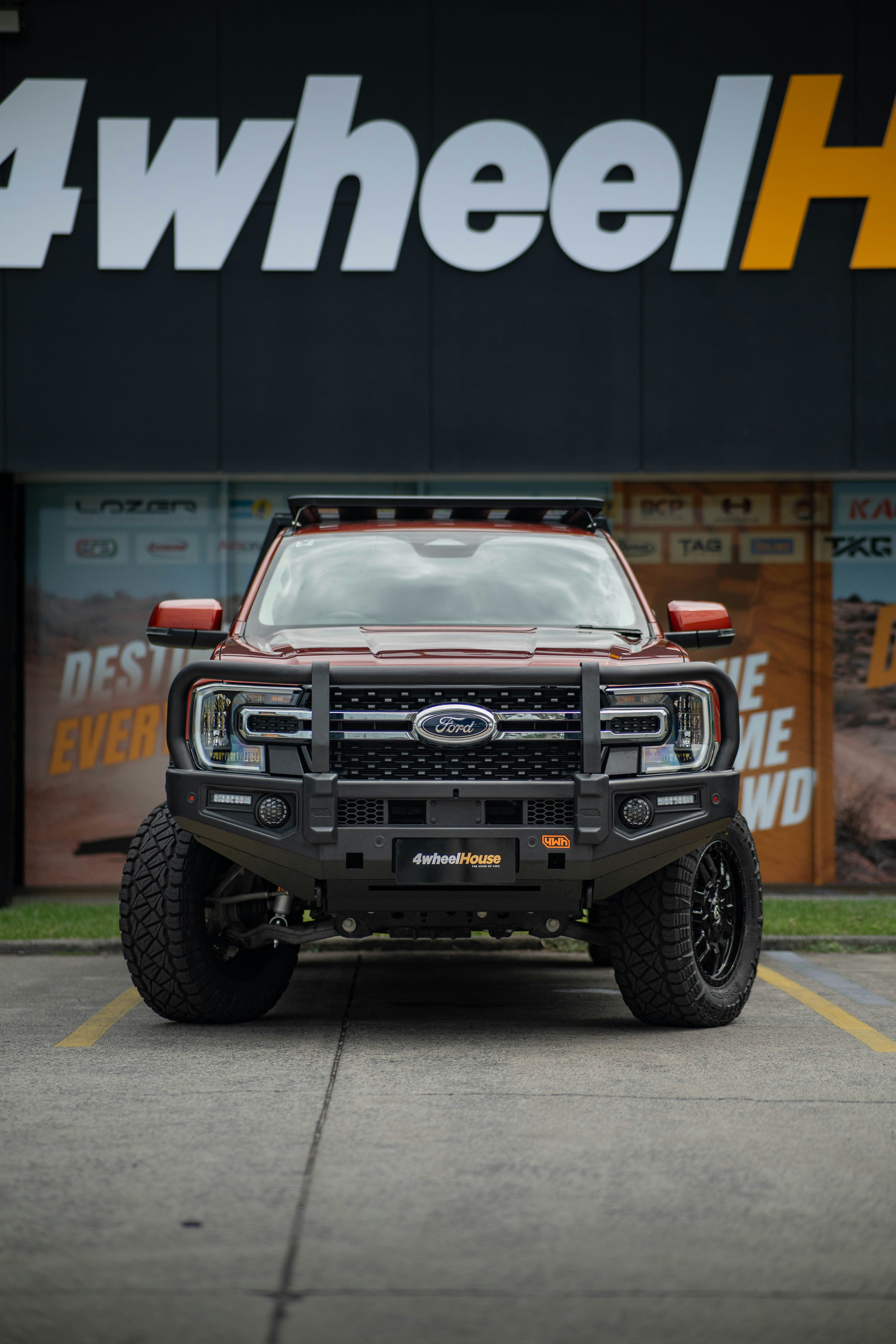 Red ford truck with bull bar and roof rack