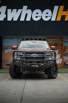 Red ford truck with bull bar and roof rack