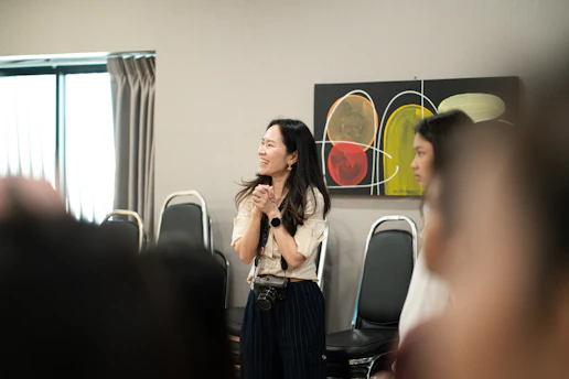 A woman clapping her hands in a meeting