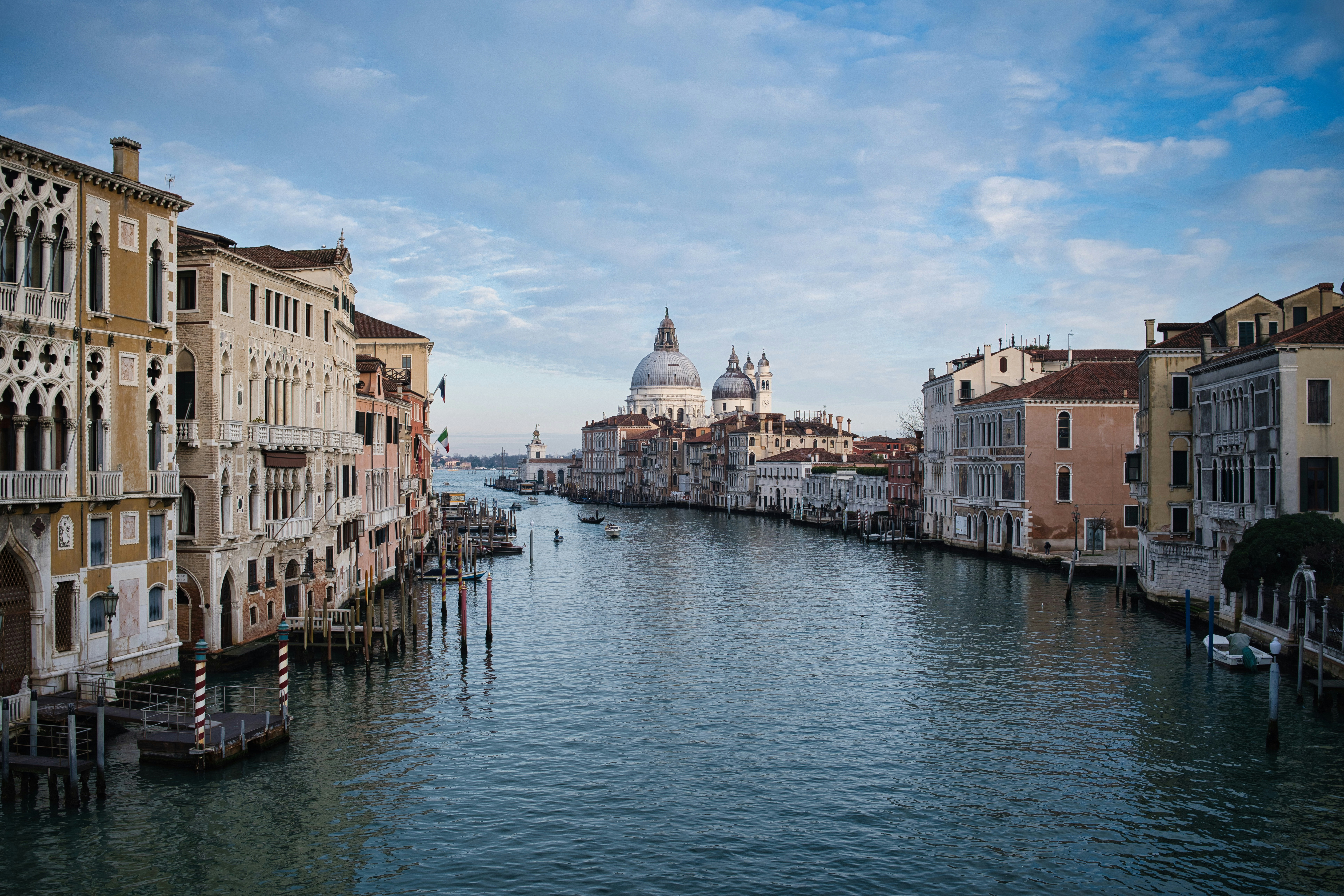 Venice canal with historic buildings and a dome.