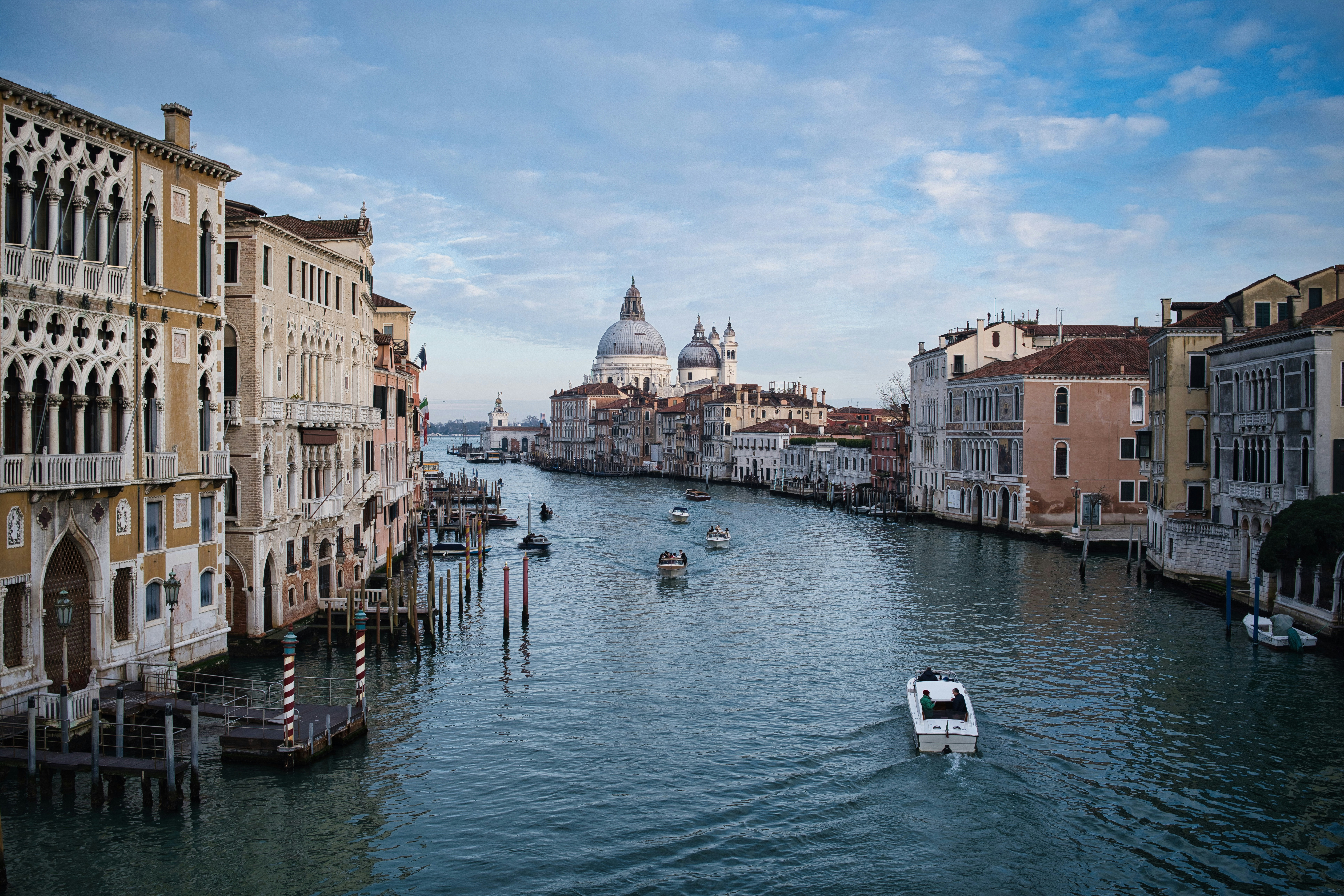 Boats on a canal in venice with historic buildings