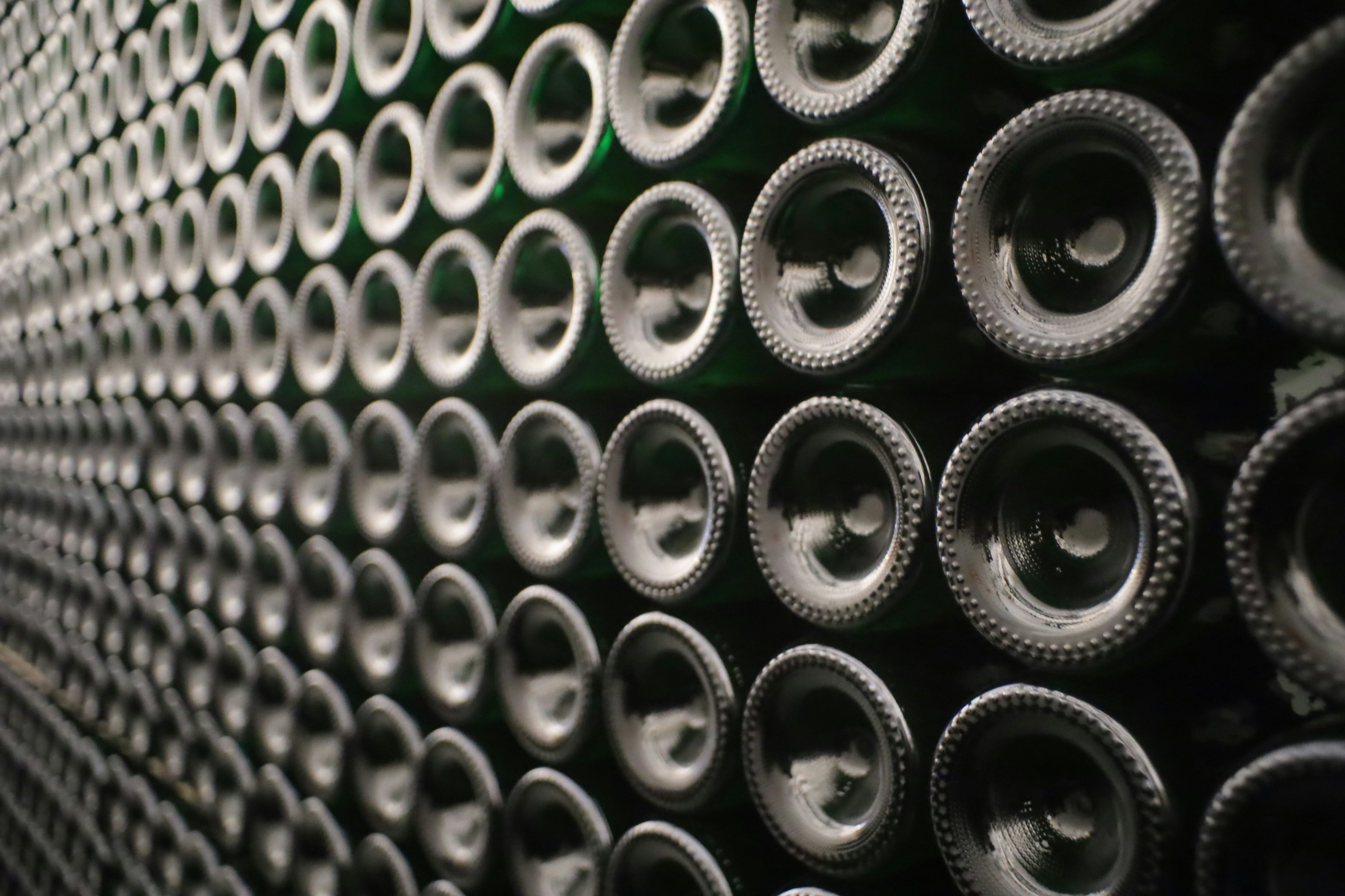 Rows of green glass bottles stacked closely together