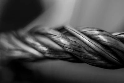 Close-up of a twisted metal wire rope.