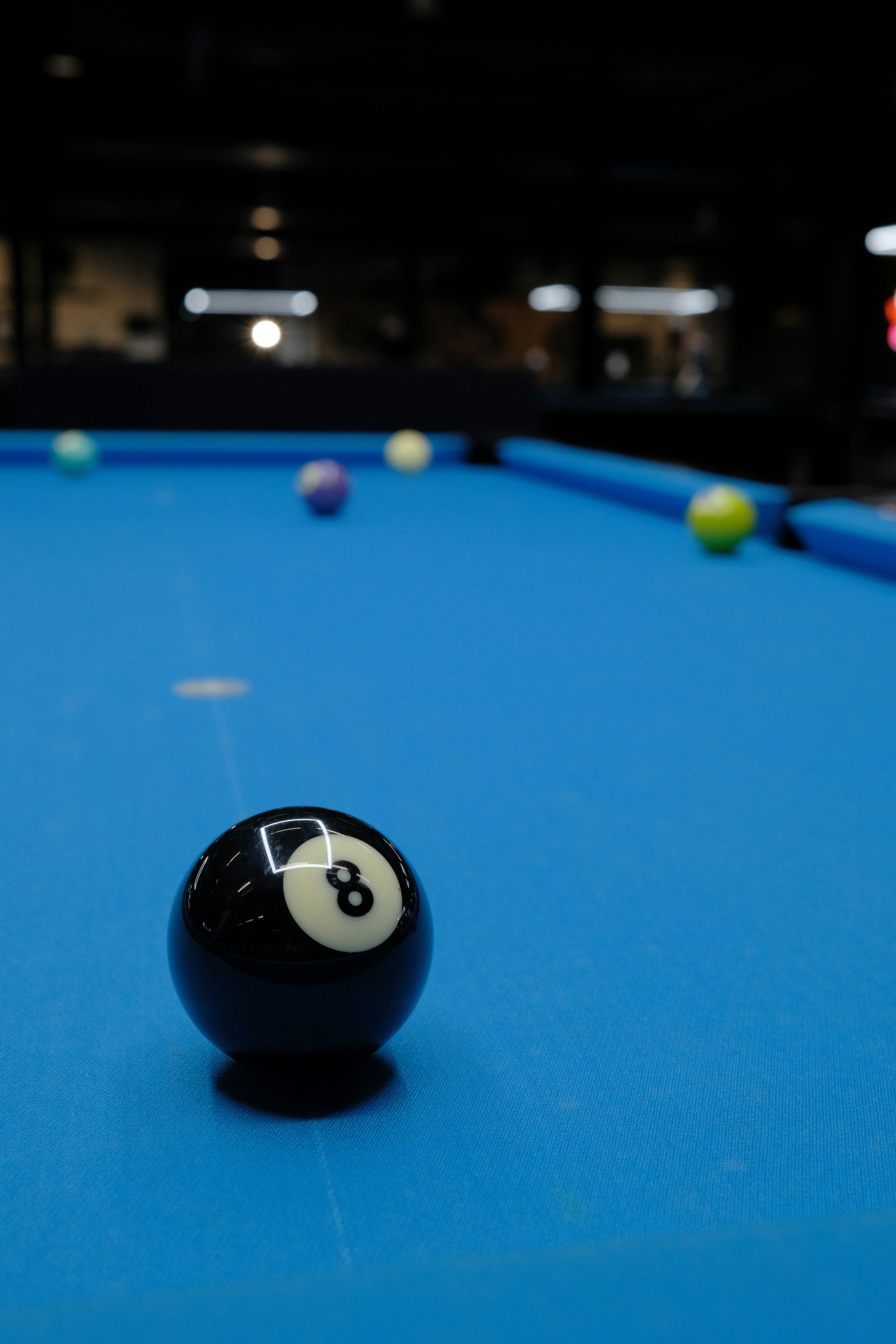 Eight ball on a blue pool table