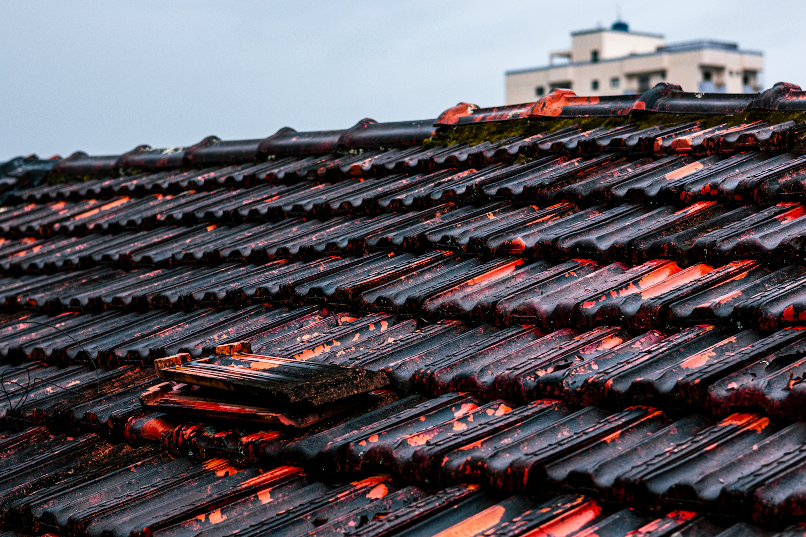 Close-up of storm-damaged roof tiles