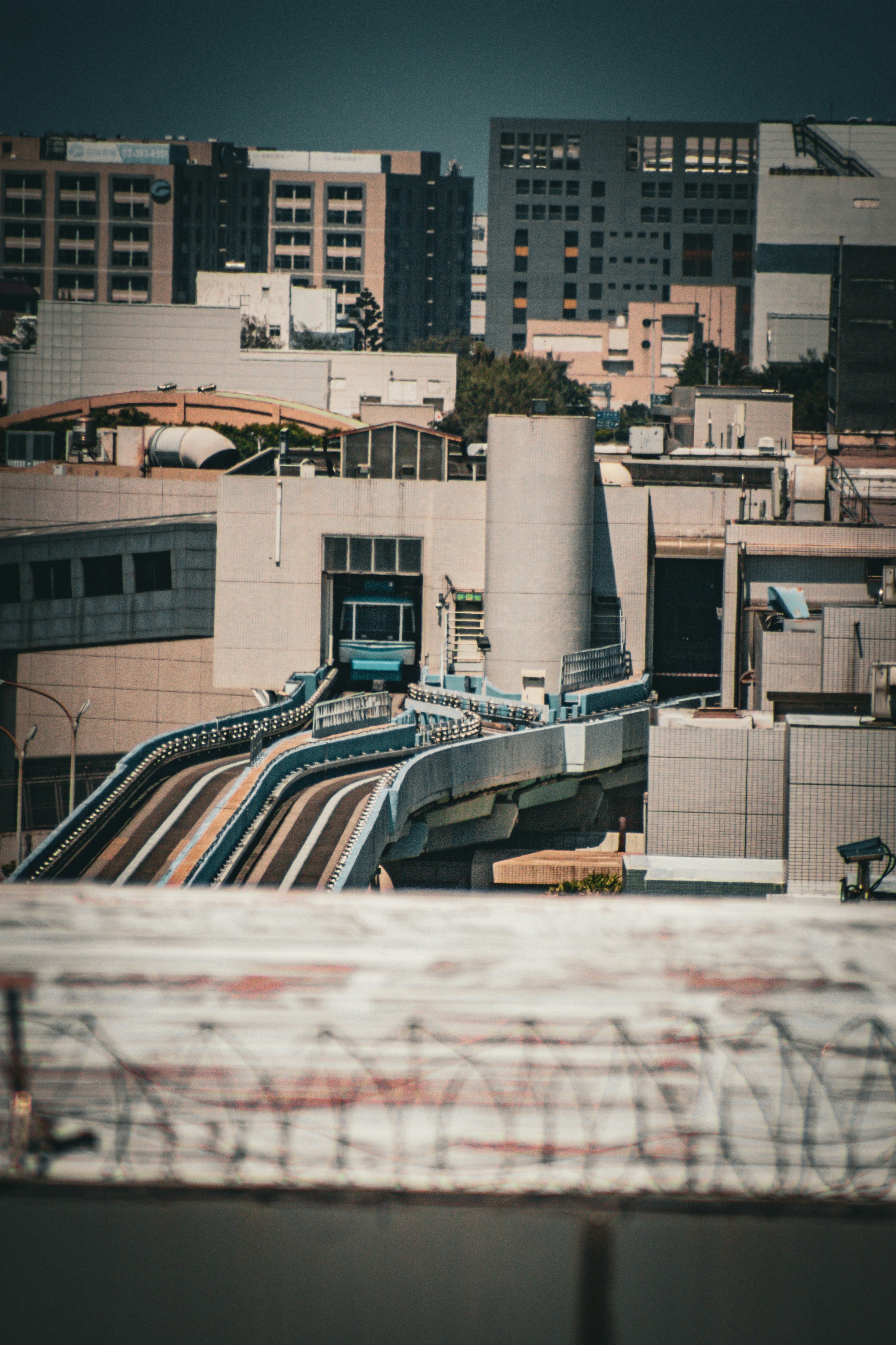 A futuristic monorail travels through a modern cityscape.