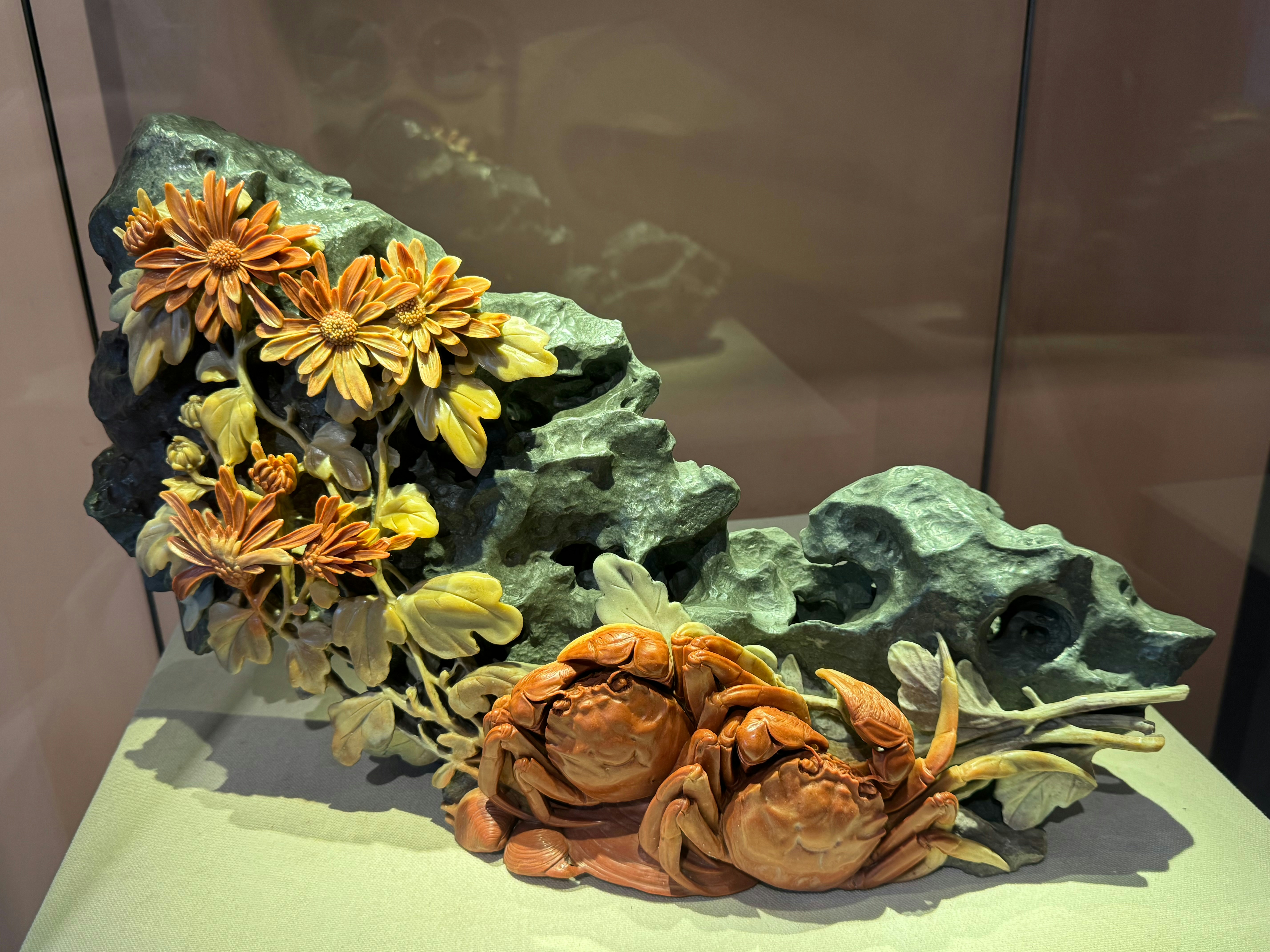 Carved stone sculpture of crabs and flowers on rock