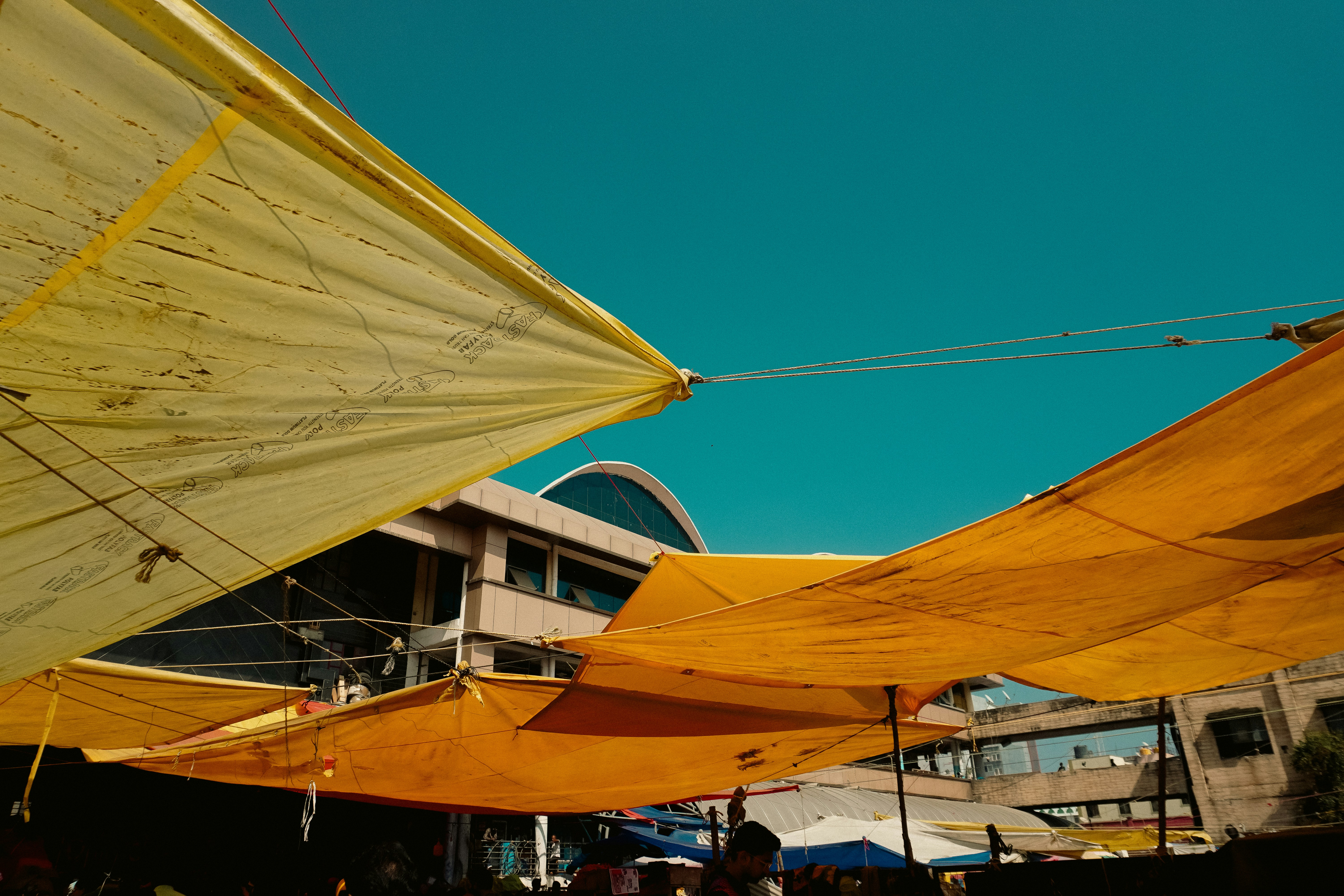 Yellow fabric shades against a bright blue sky.