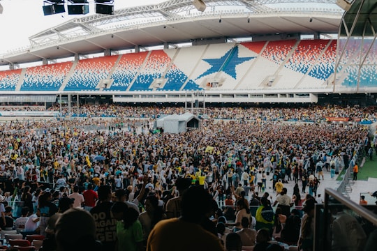 Large crowd gathered in a stadium with patriotic decorations