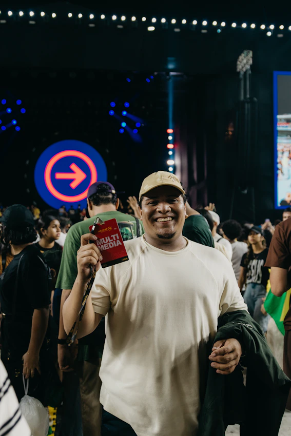 Man holding a multimedia pass at a crowded event
