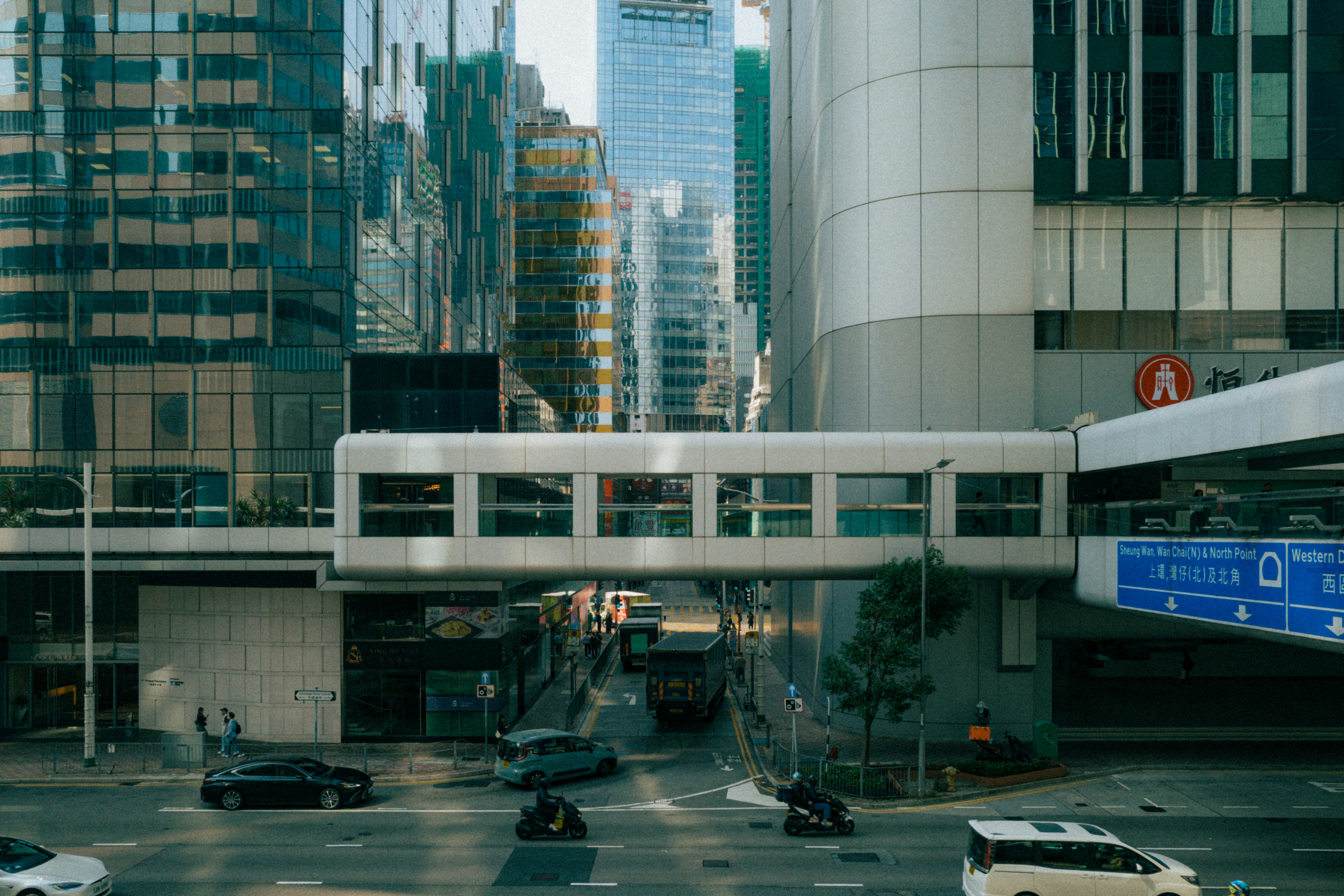 Modern city street with cars and tall buildings