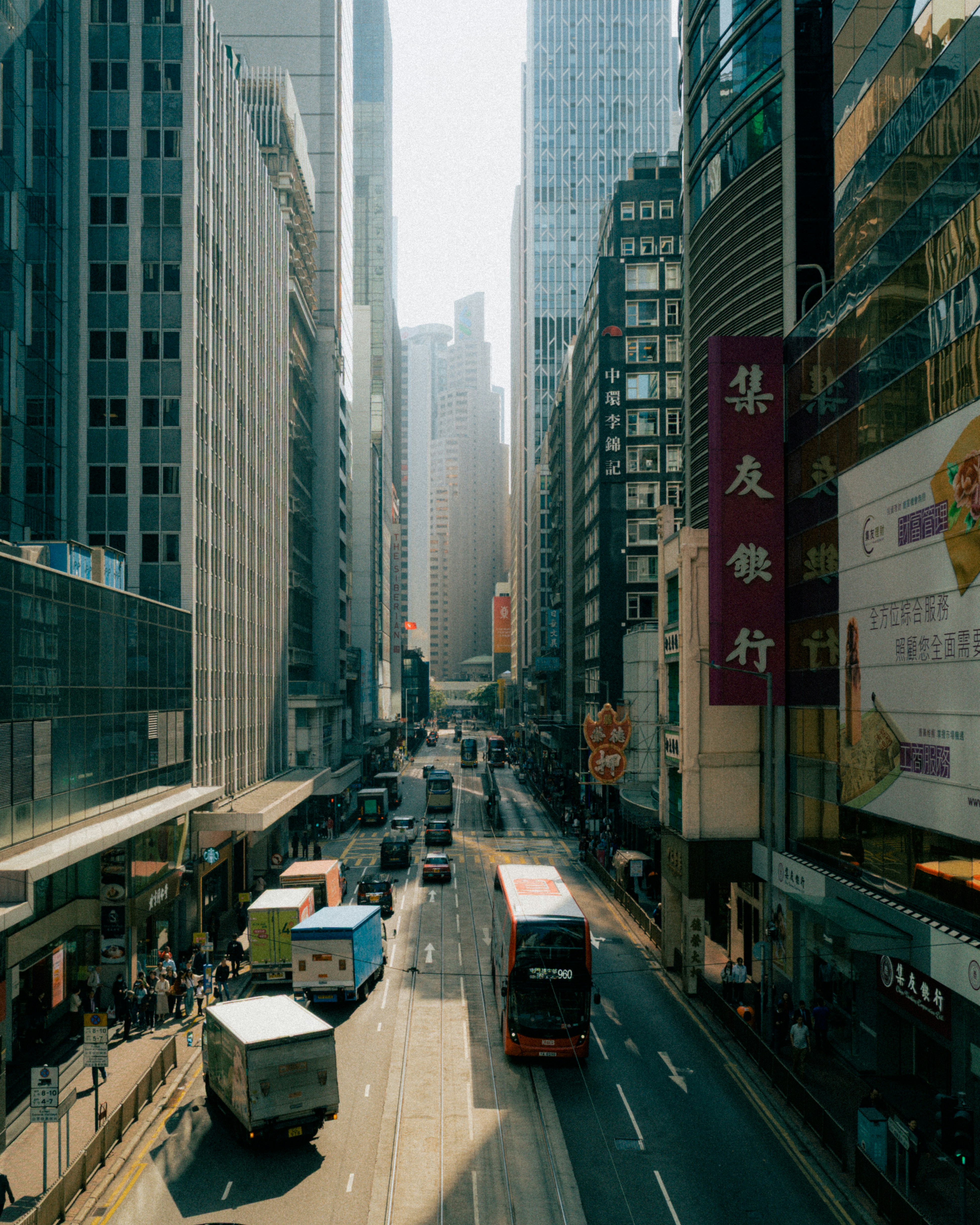 Photo of Busy street with traffic and tall buildings in city. by Alex Safareli