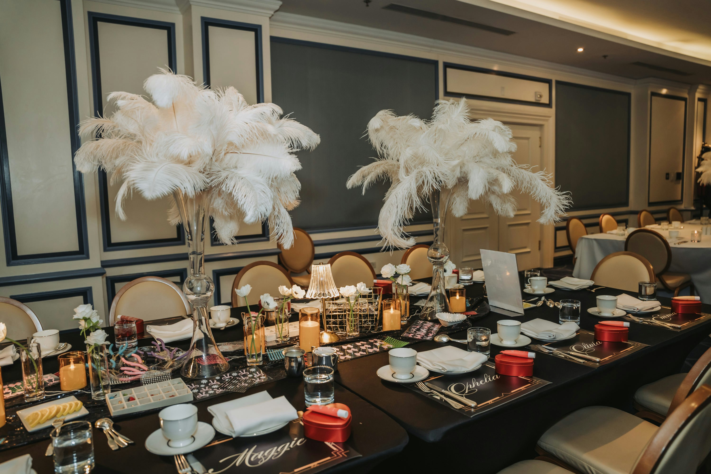 Elegant table setting with feather centerpieces and place settings.