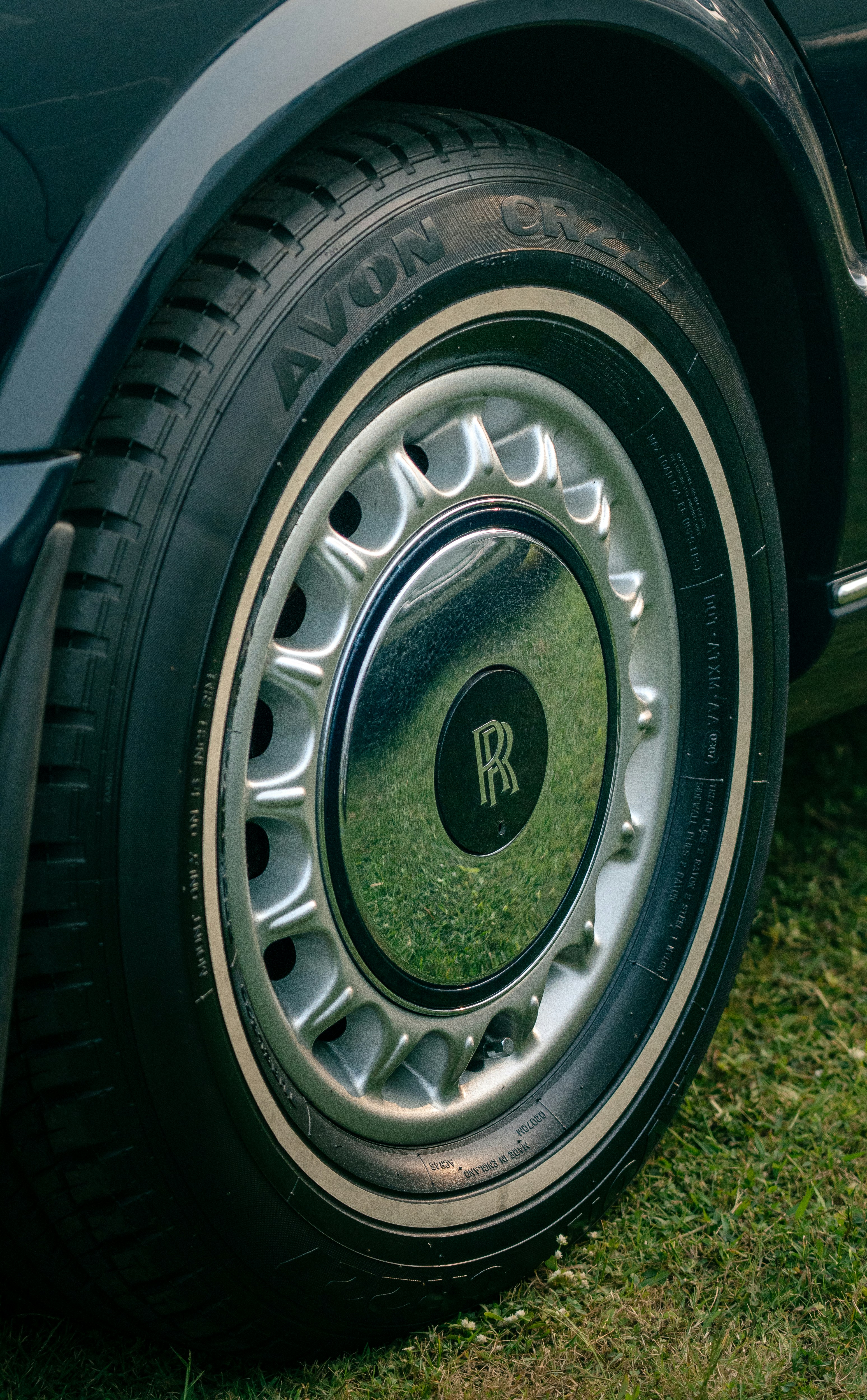 Close-up of a vintage rolls-royce tire and wheel.