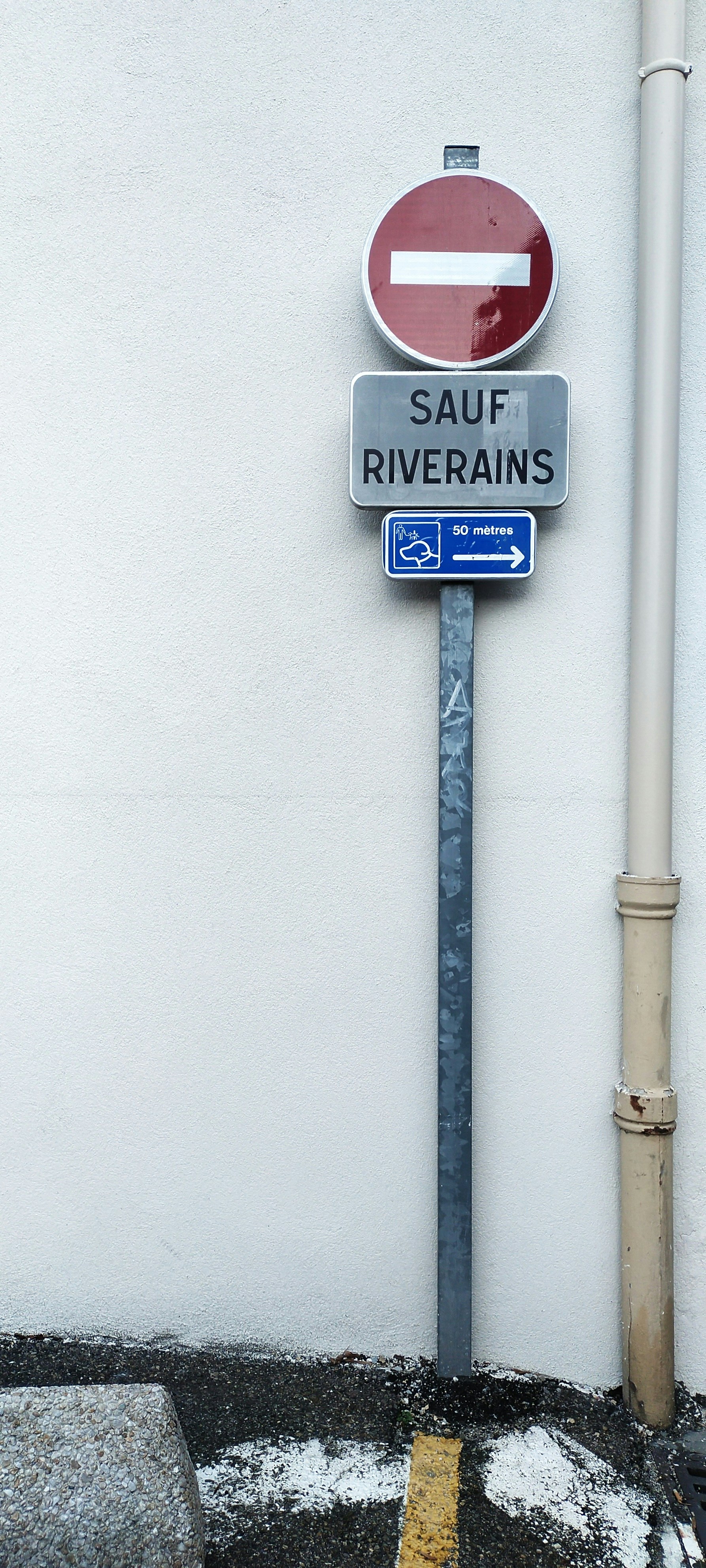 Traffic signs indicating no entry except for residents.