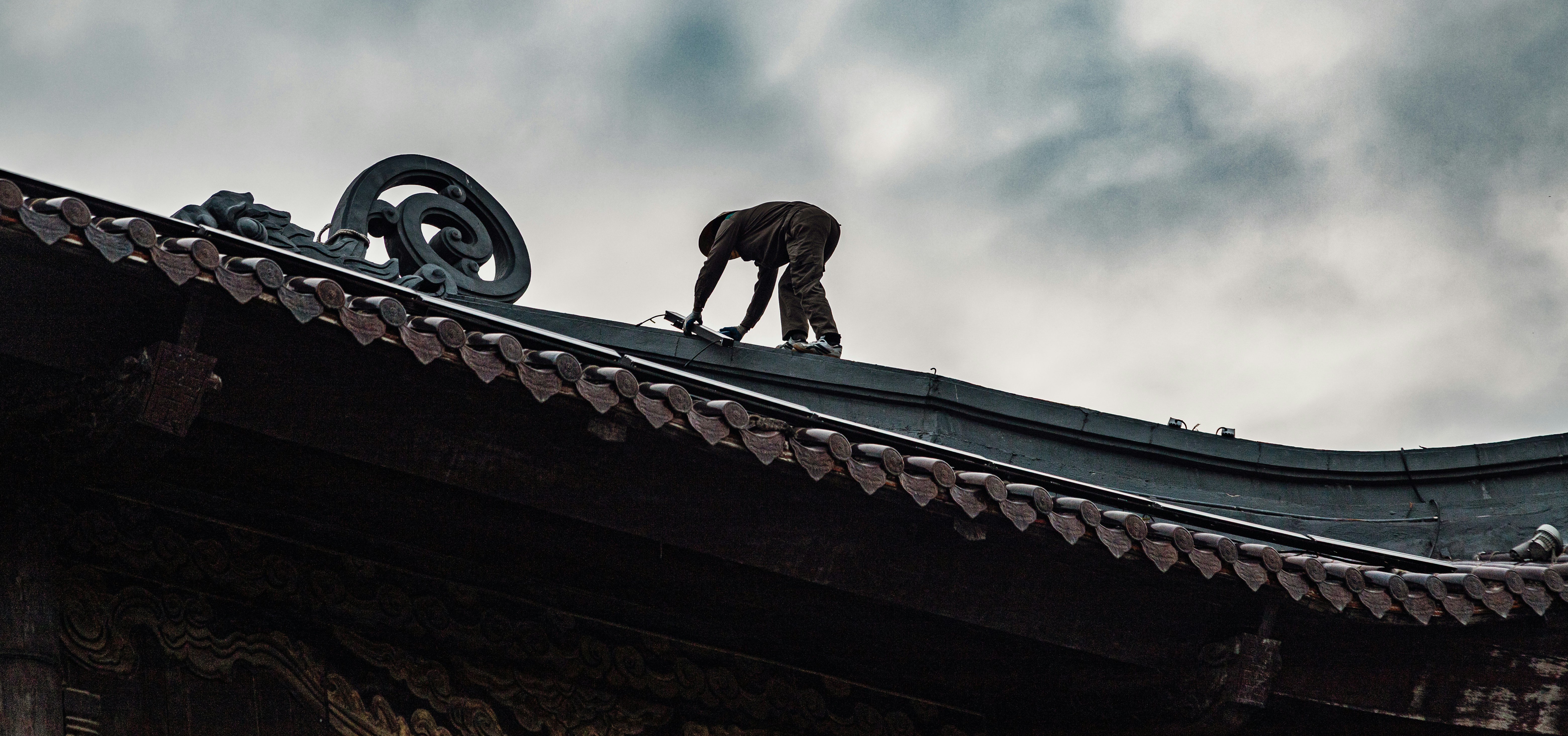 A monkey on a traditional asian roof