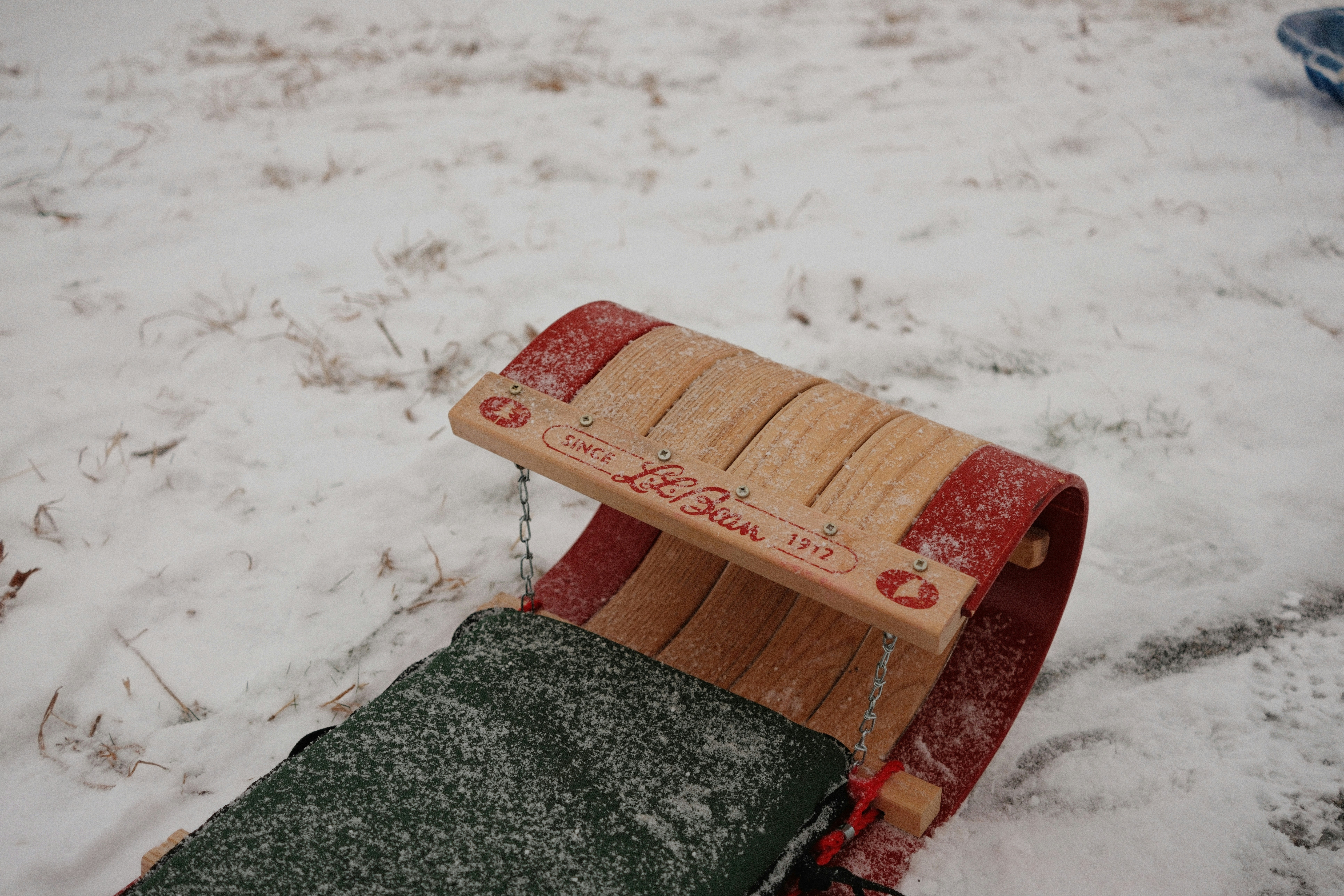 Wooden sled covered in snow on a winter day
