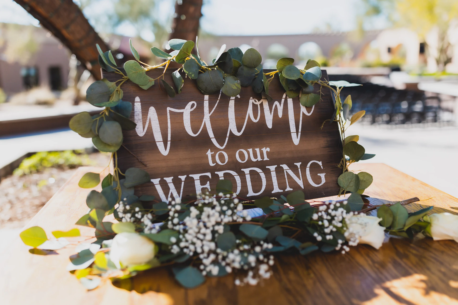 Wooden wedding welcome sign with eucalyptus and flowers